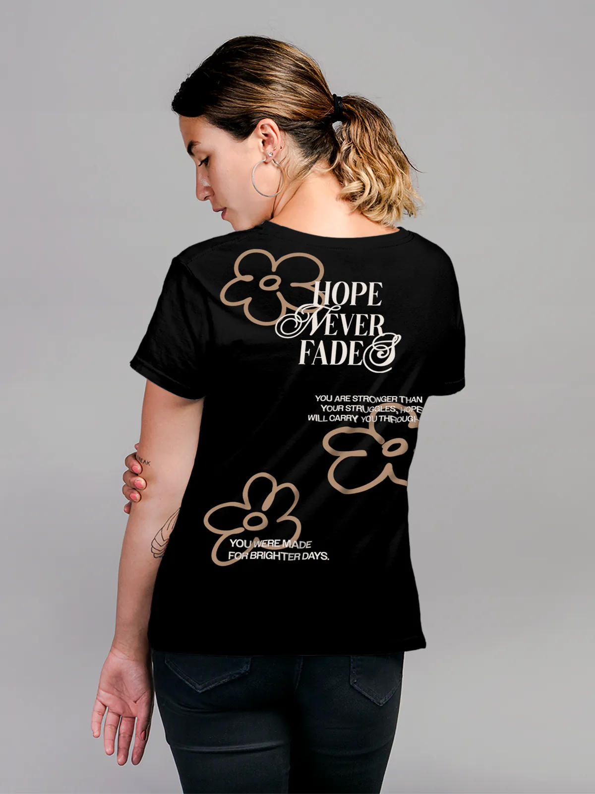 Model wearing Women's Black Round Neck T-shirt with 'Hope Never Fades' design, offering effortless style and premium comfort