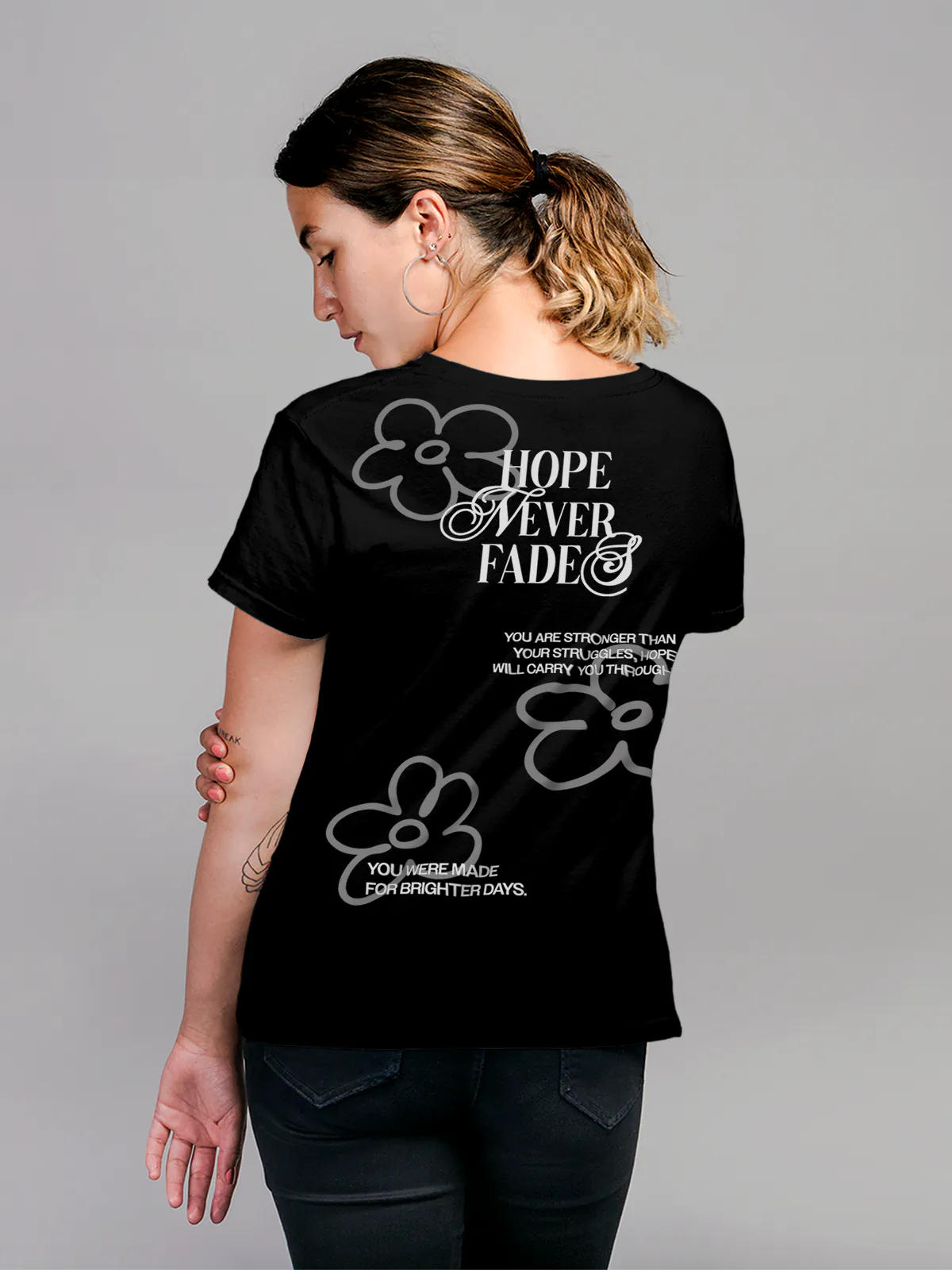 Model wearing Women's Black Round Neck T-shirt with 'Hope Never Fades' design, offering effortless style and premium comfort