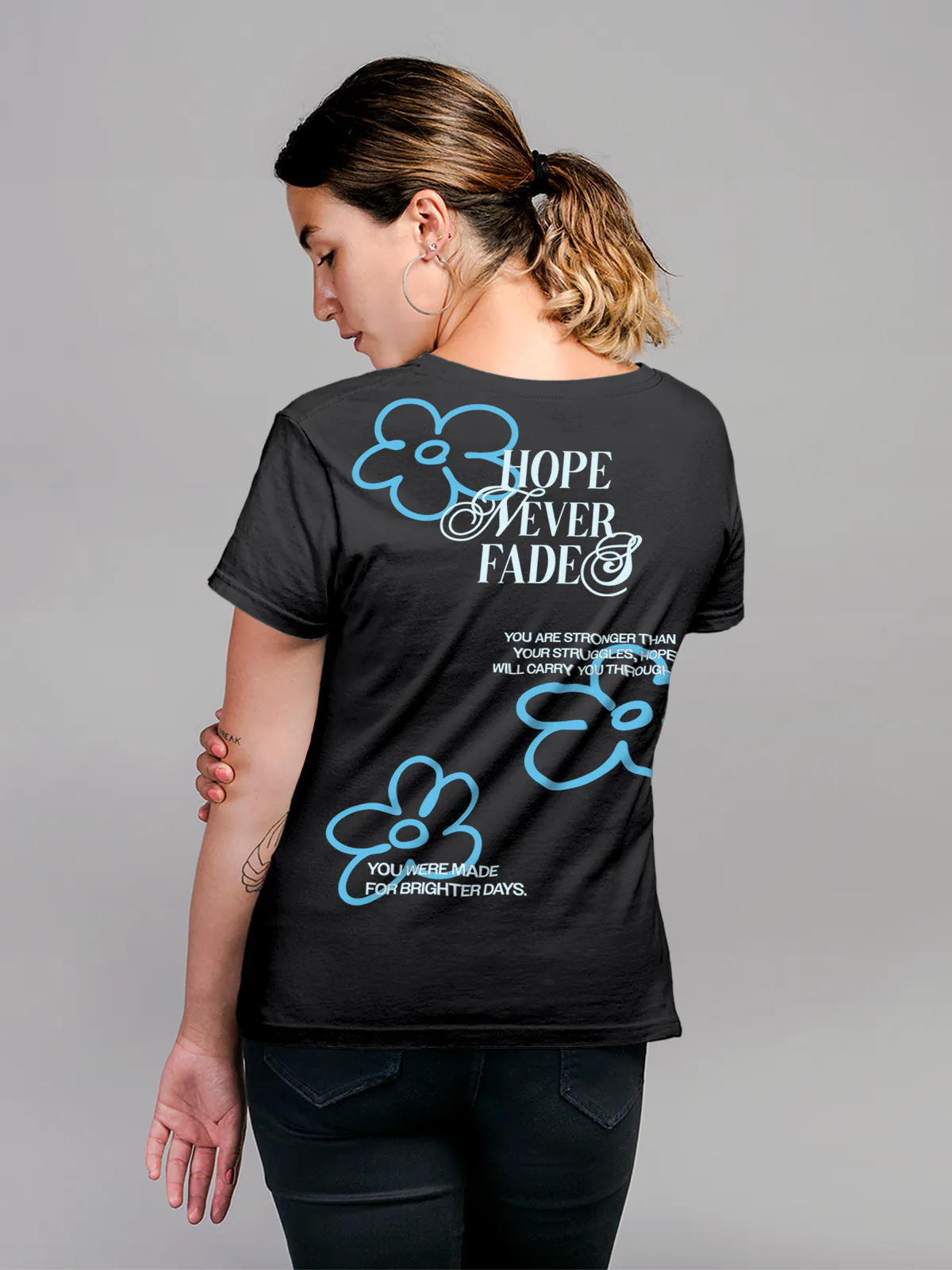 Model wearing Women's Dark Grey Round Neck T-shirt with 'Hope Never Fades' design, offering effortless style and premium comfort