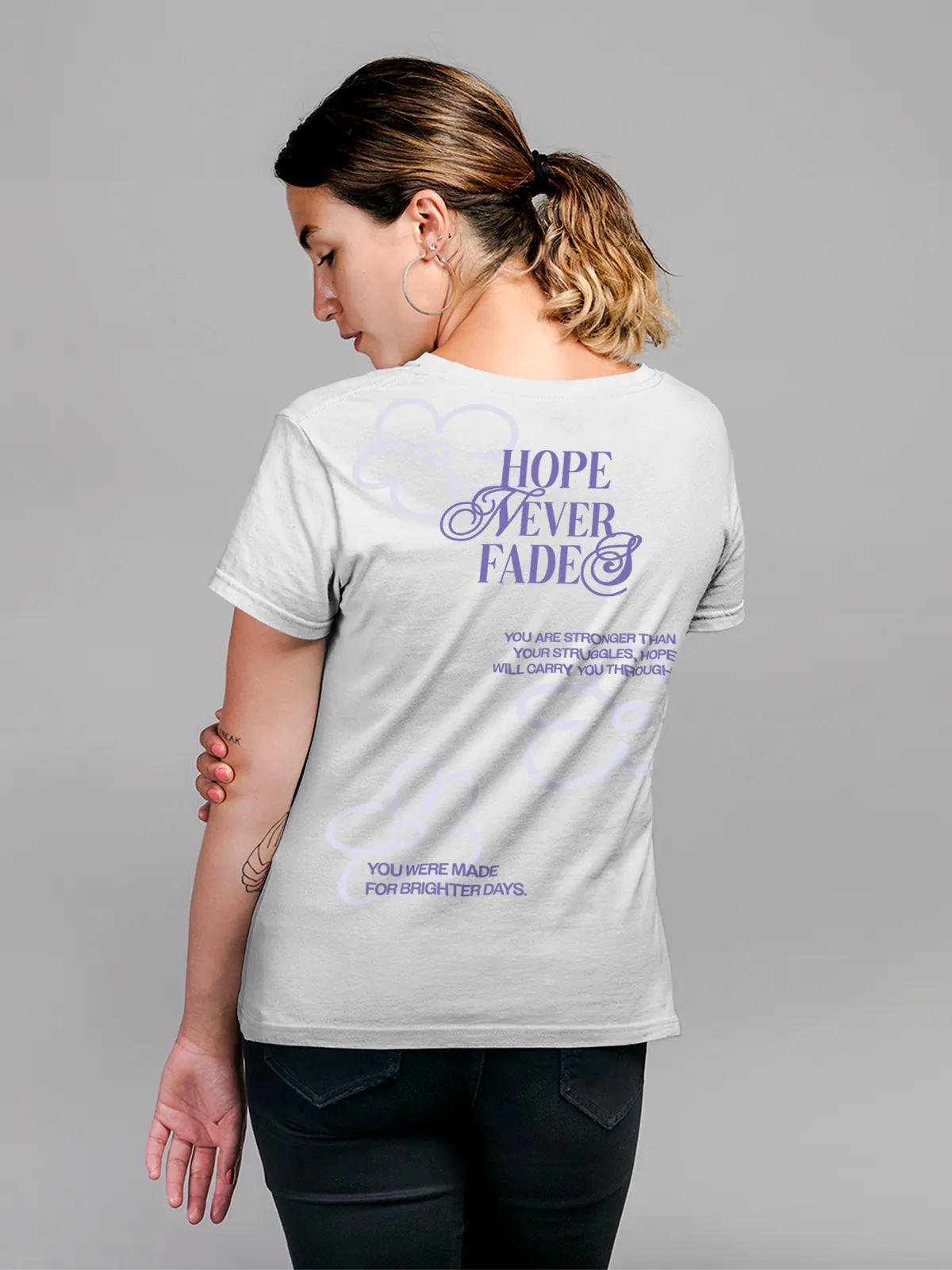 Model wearing Women's White Round Neck T-shirt with 'Hope Never Fades' design, offering effortless style and premium comfort