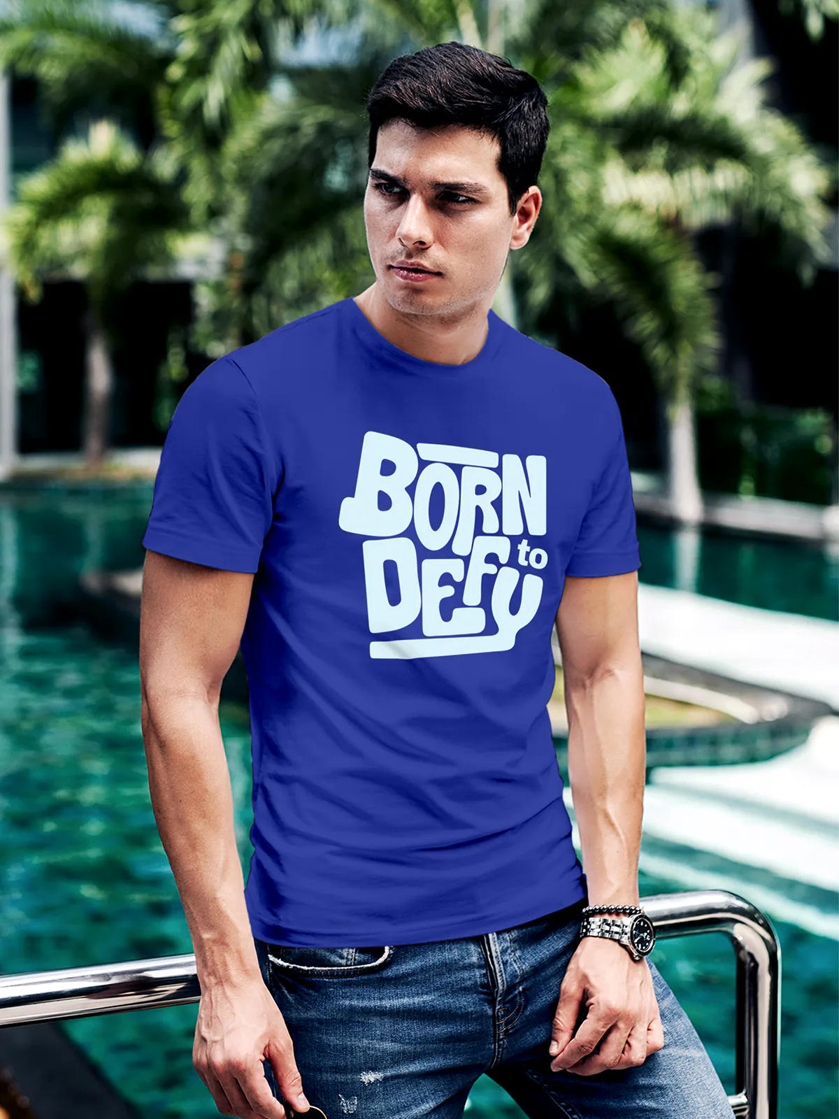 Model wearing Men's Blue Round Neck T-shirt with 'Born To Defy' design, offering effortless style and premium comfort