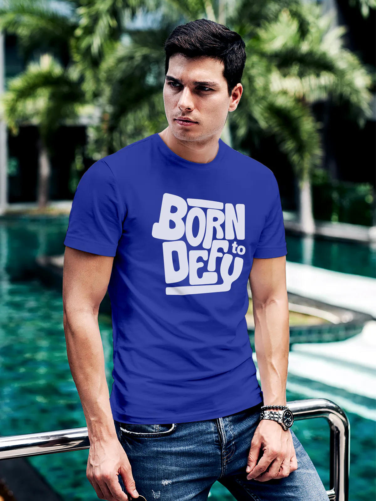 Model wearing Men's Blue Round Neck T-shirt with 'Born To Defy' design, offering effortless style and premium comfort