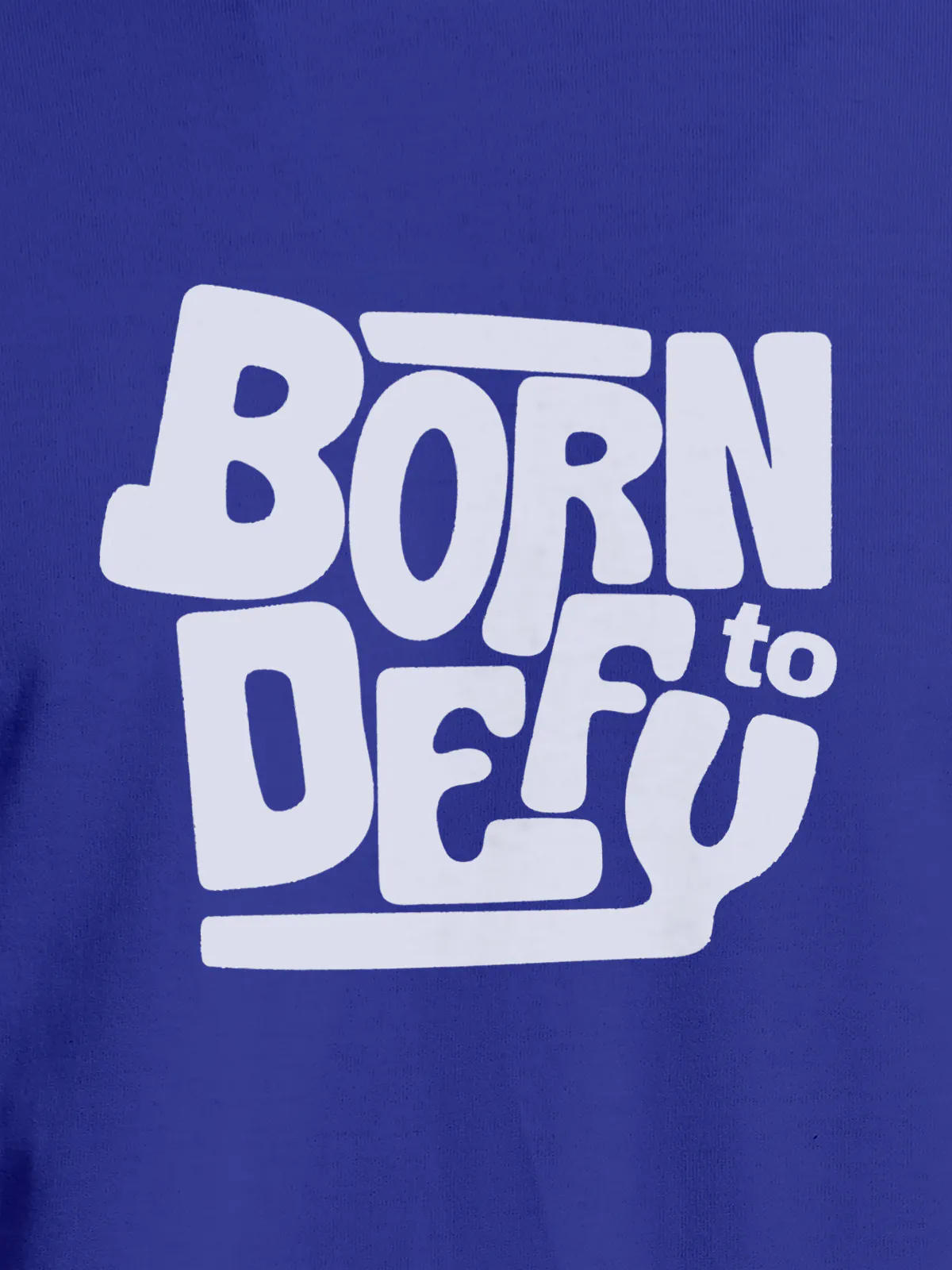 Close up of 'Born To Defy' design on Men's Blue Round Neck T-shirt, highlighting intricate details and vibrant print.