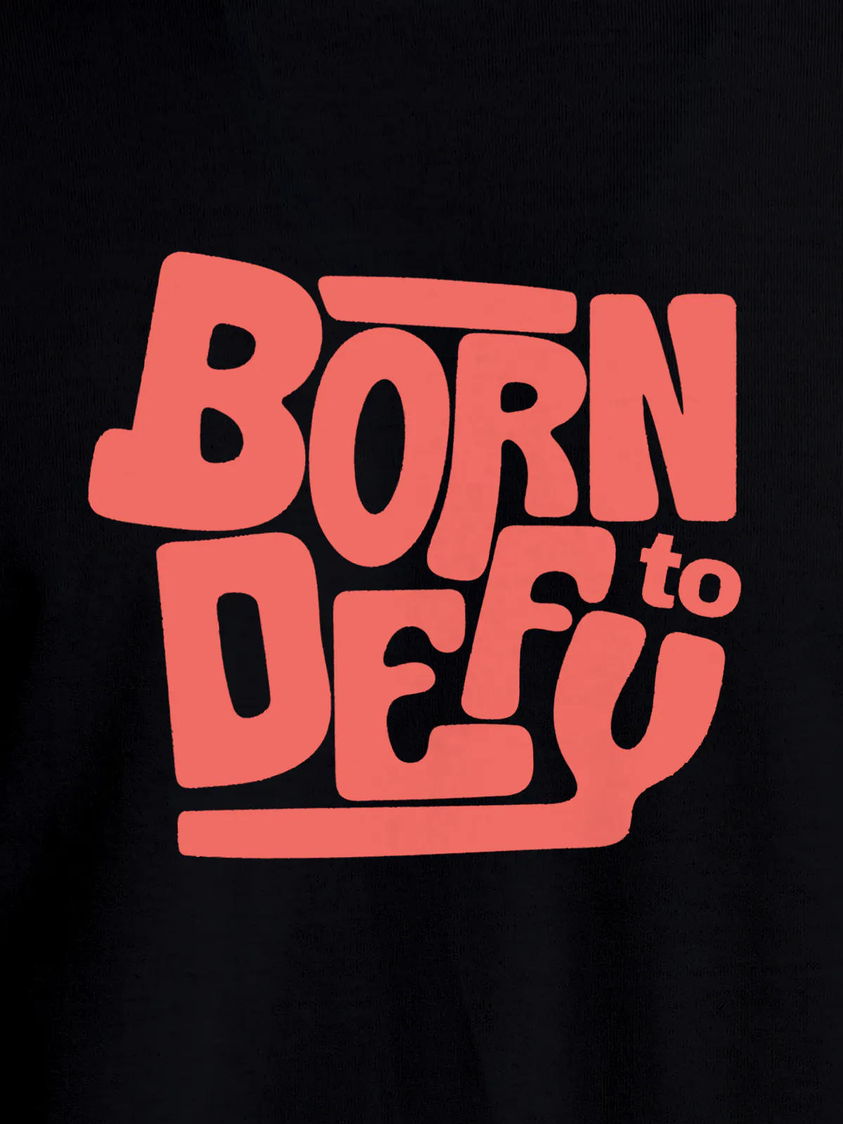 Close up of 'Born To Defy' design on Men's Black Round Neck T-shirt, highlighting intricate details and vibrant print.
