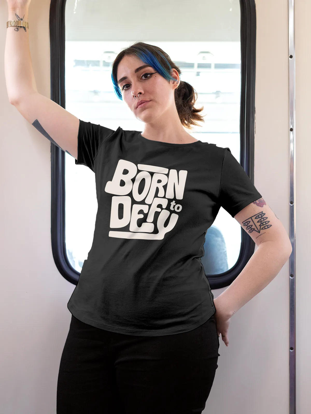 Model wearing Women's Dark Grey Round Neck T-shirt with 'Born To Defy' design, offering effortless style and premium comfort