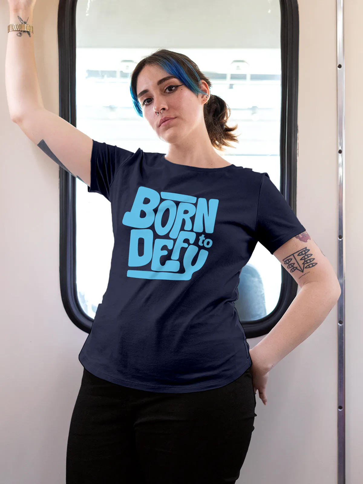 Model wearing Women's Navy Blue Round Neck T-shirt with 'Born To Defy' design, offering effortless style and premium comfort