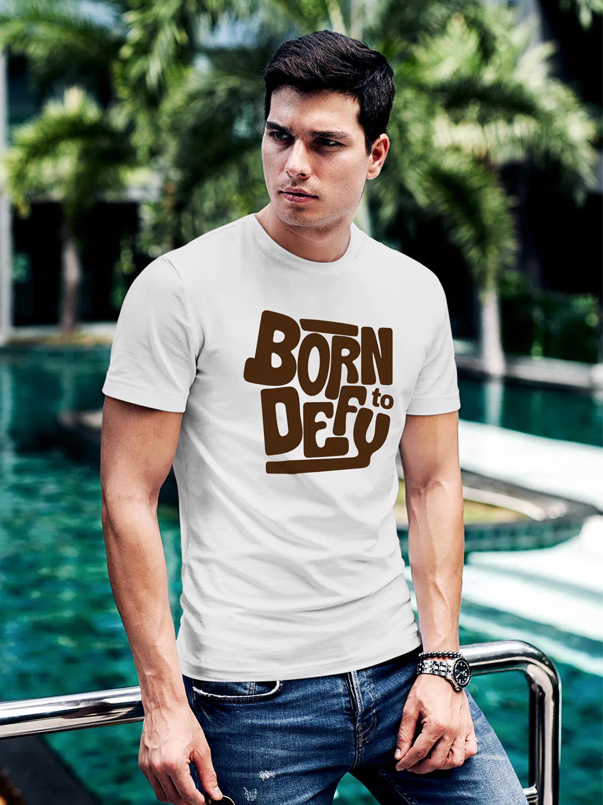 Model wearing Men's White Round Neck T-shirt with 'Born To Defy' design, offering effortless style and premium comfort