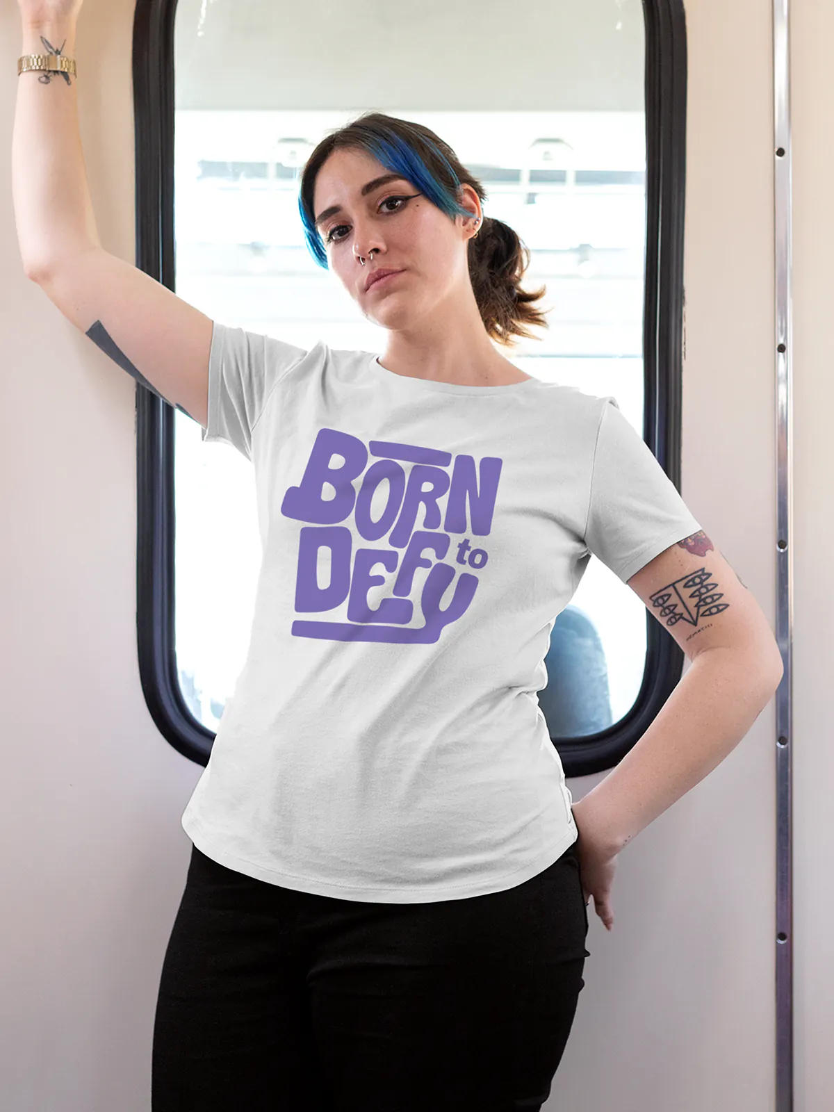 Model wearing Women's White Round Neck T-shirt with 'Born To Defy' design, offering effortless style and premium comfort