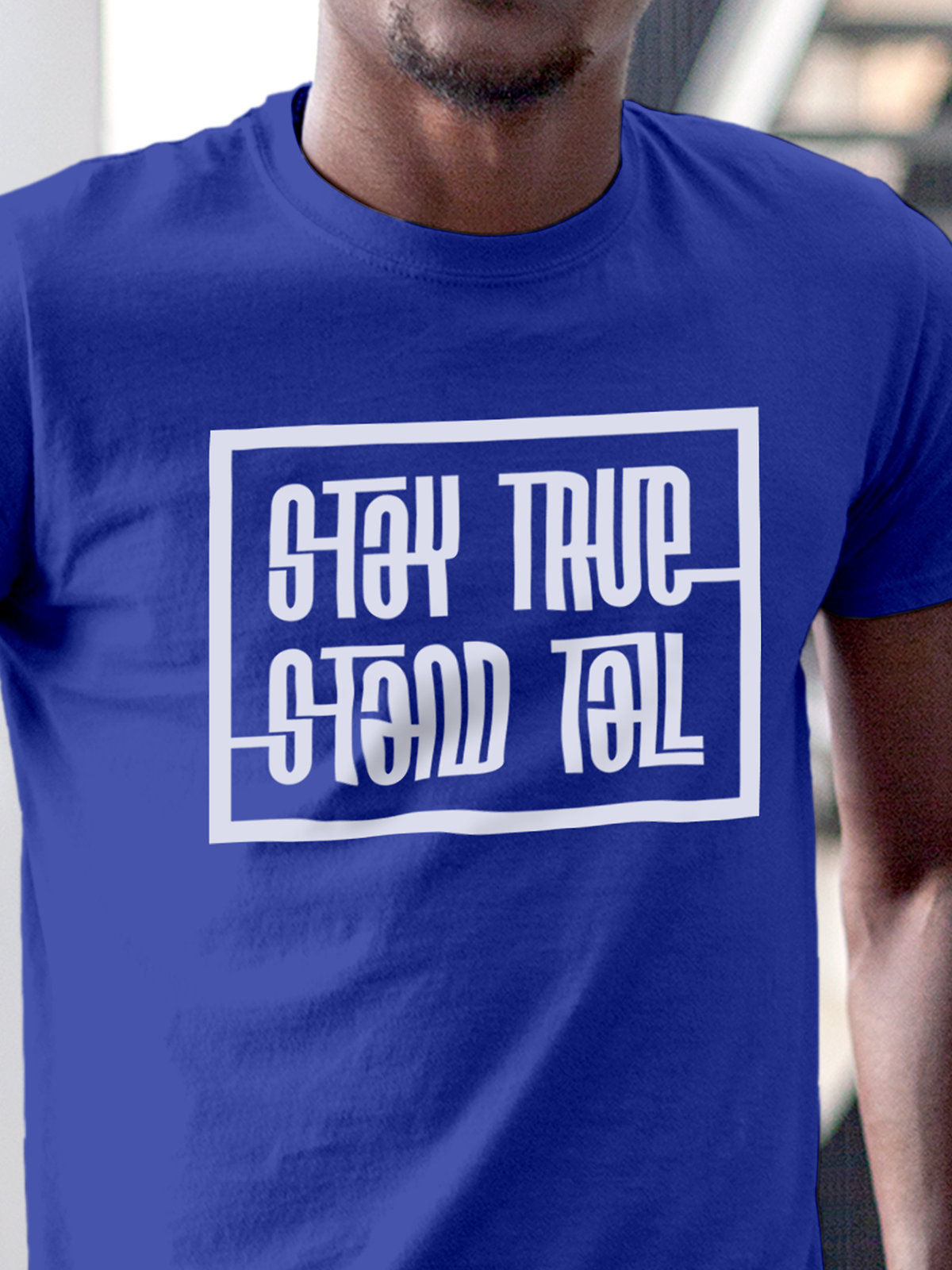 Close up of 'Stay True Stand Tall' design on Men's Blue Round Neck T-shirt, highlighting intricate details and vibrant print.