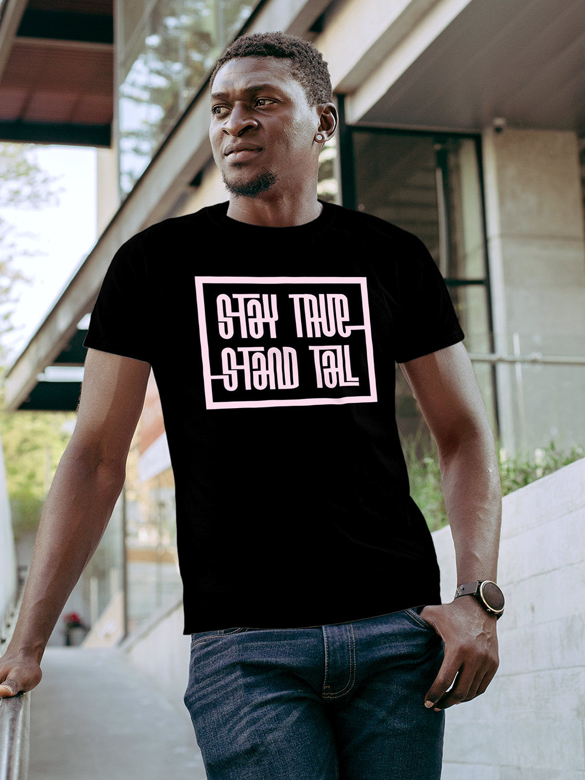 Model wearing Men's Black Round Neck T-shirt with 'Stay True Stand Tall' design, offering effortless style and premium comfort