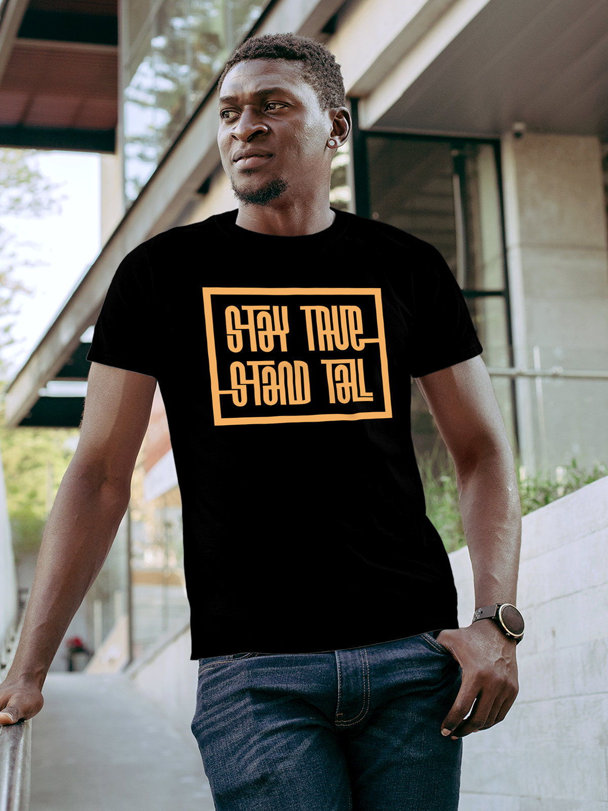 Model wearing Men's Black Round Neck T-shirt with 'Stay True Stand Tall' design, offering effortless style and premium comfort