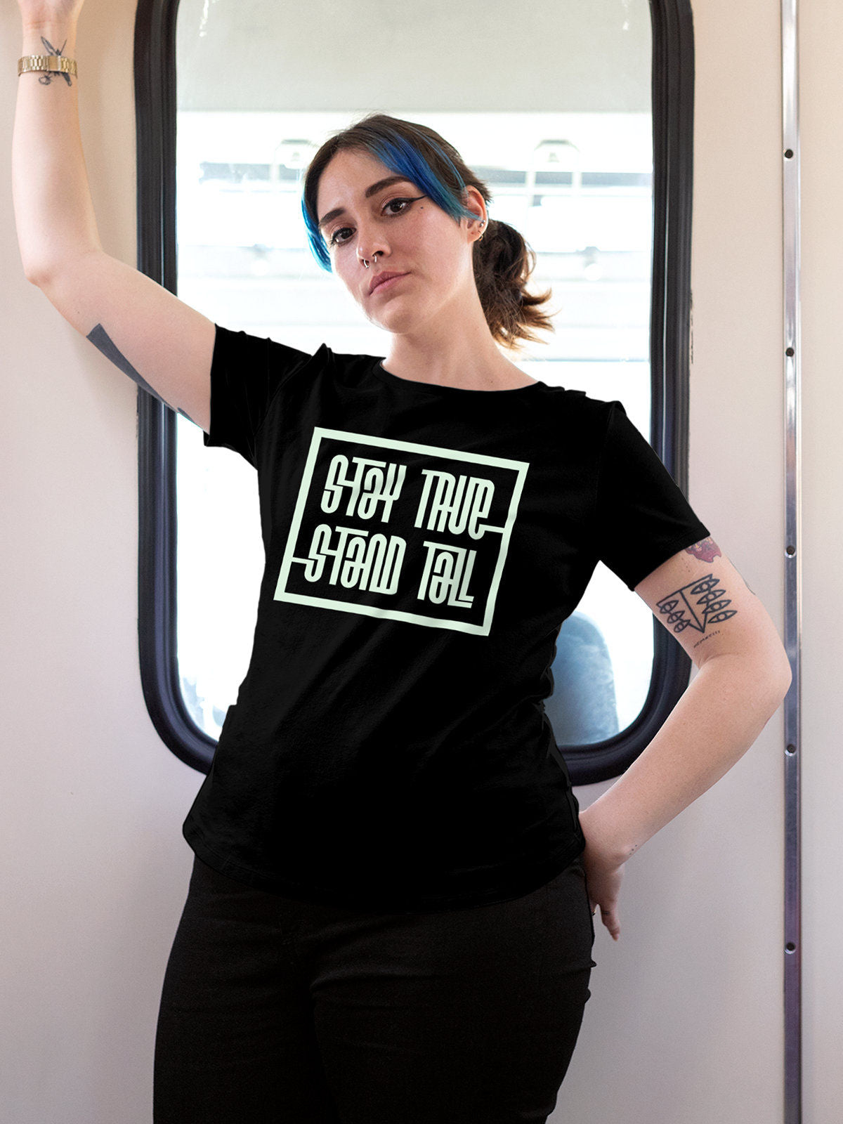 Model wearing Women's Black Round Neck T-shirt with 'Stay True Stand Tall' design, offering effortless style and premium comfort