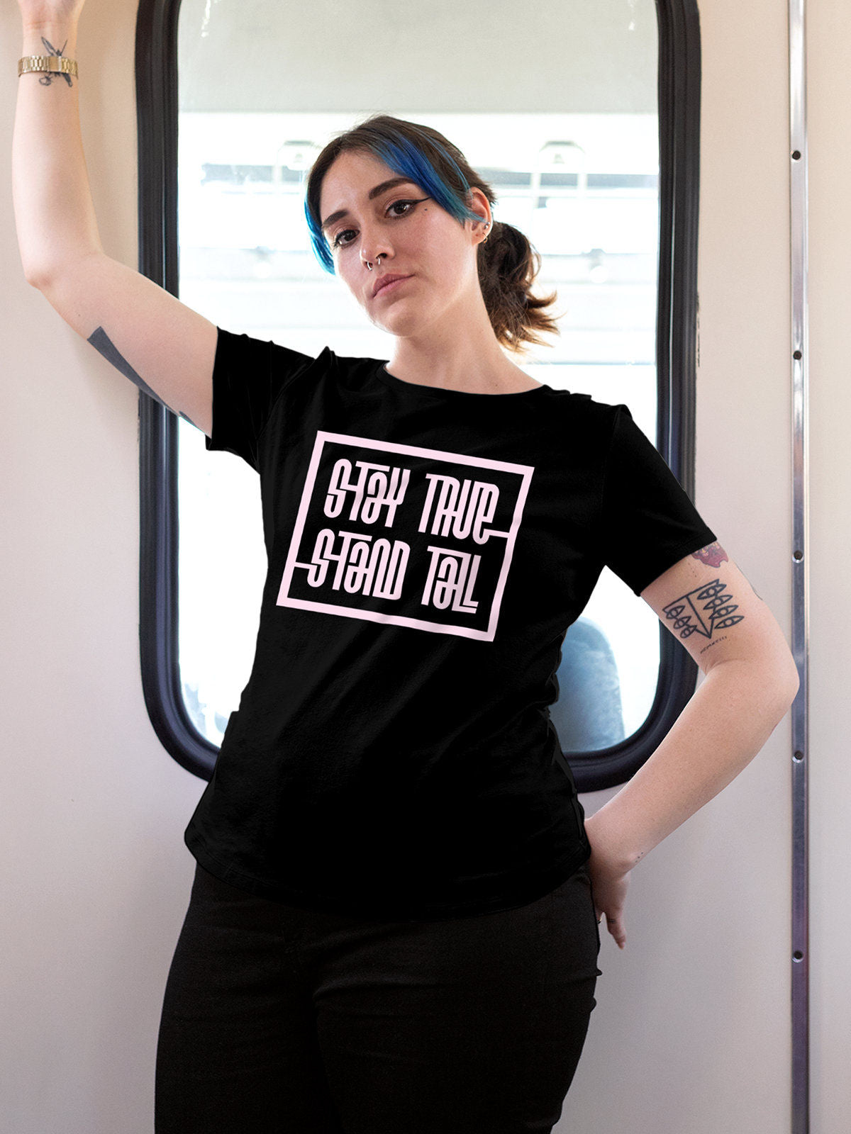 Model wearing Women's Black Round Neck T-shirt with 'Stay True Stand Tall' design, offering effortless style and premium comfort