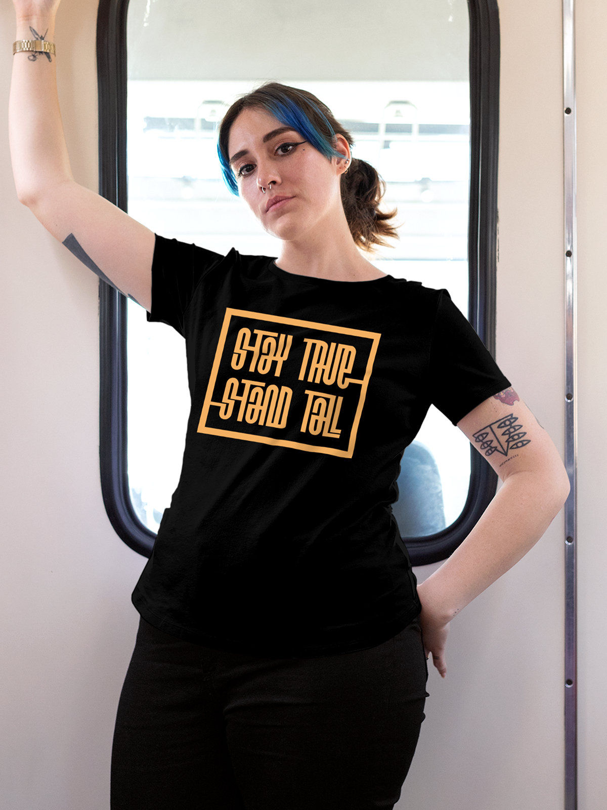 Model wearing Women's Black Round Neck T-shirt with 'Stay True Stand Tall' design, offering effortless style and premium comfort