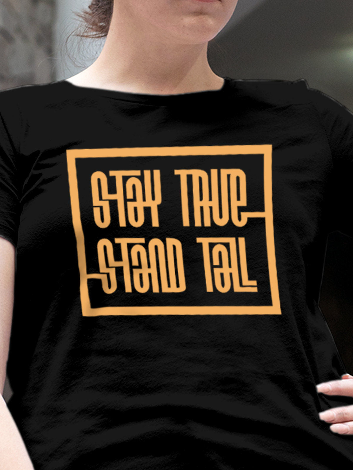 Close up of 'Stay True Stand Tall' design on Women's Black Round Neck T-shirt, highlighting intricate details and vibrant print.