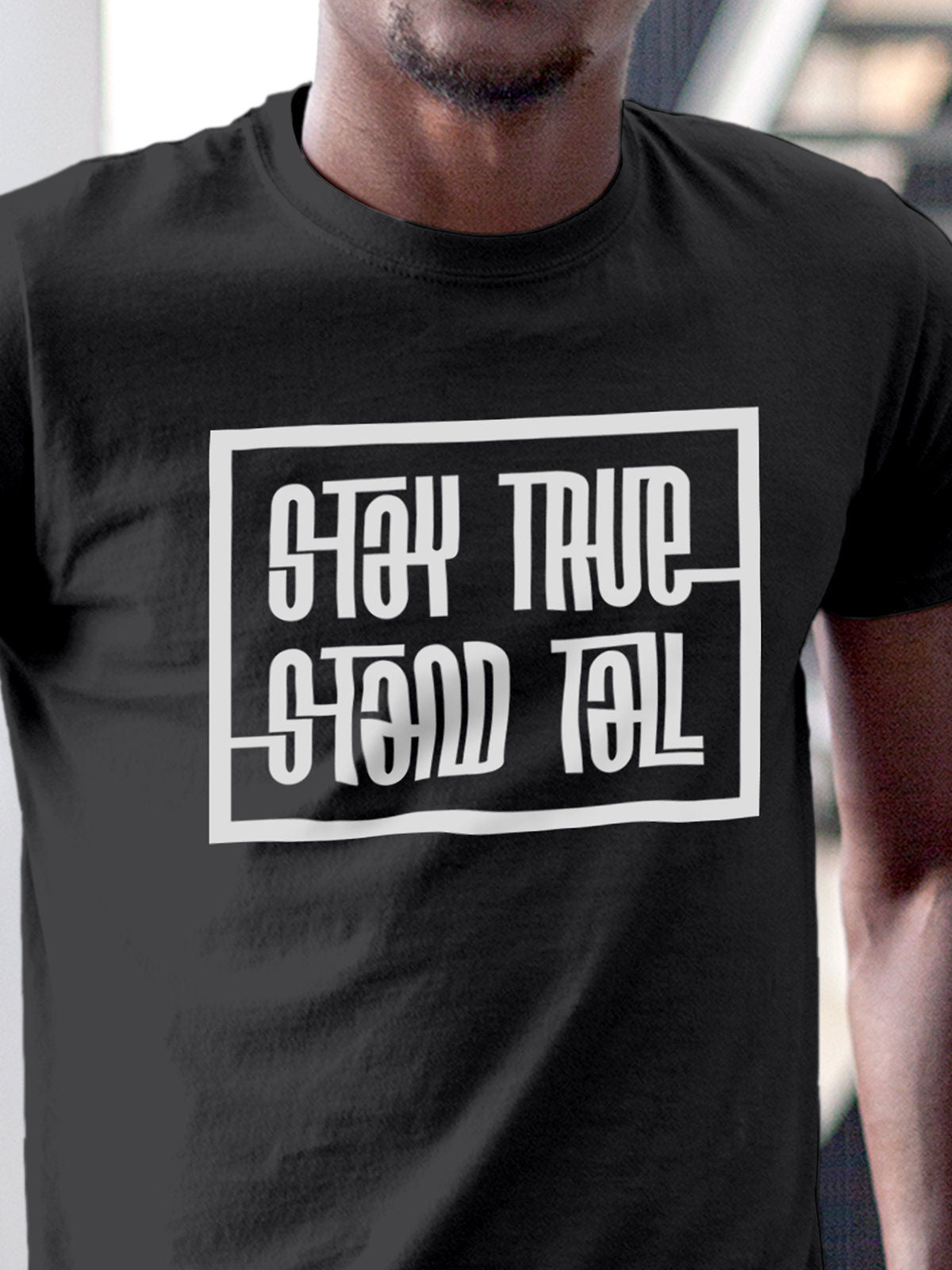 Close up of 'Stay True Stand Tall' design on Men's Dark Grey Round Neck T-shirt, highlighting intricate details and vibrant print.