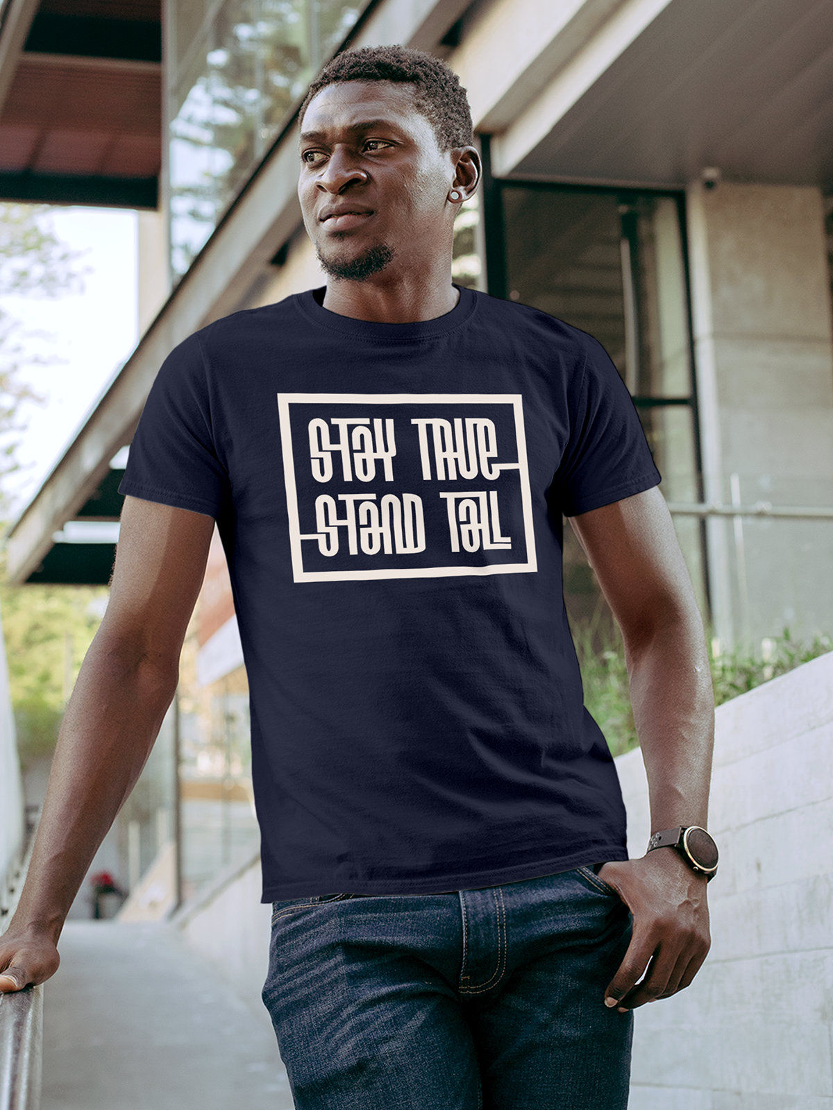 Model wearing Men's Navy Blue Round Neck T-shirt with 'Stay True Stand Tall' design, offering effortless style and premium comfort