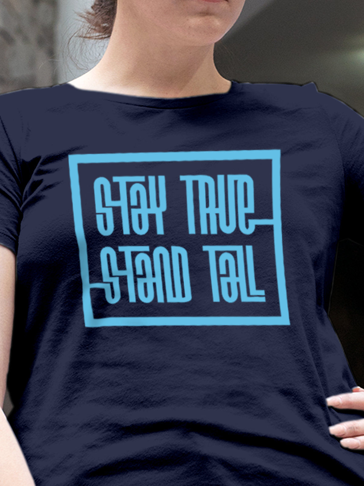 Close up of 'Stay True Stand Tall' design on Women's Navy Blue Round Neck T-shirt, highlighting intricate details and vibrant print.