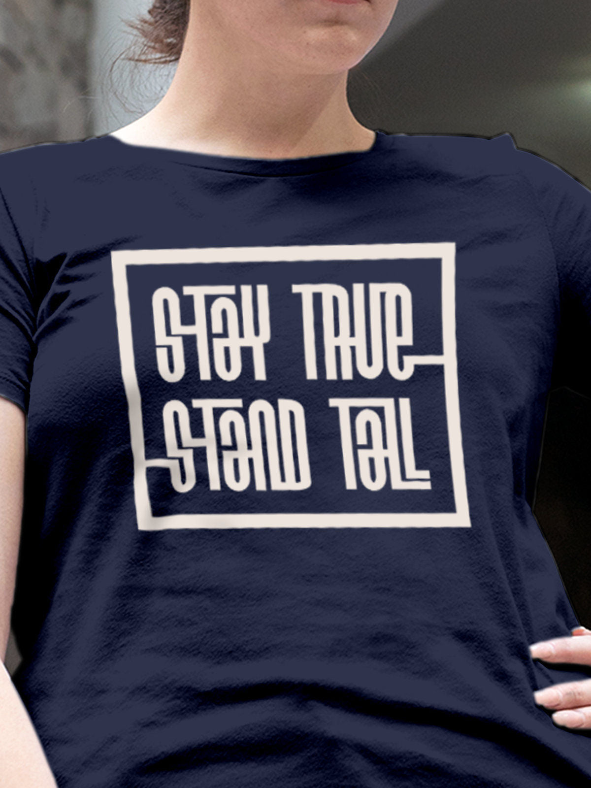 Close up of 'Stay True Stand Tall' design on Women's Navy Blue Round Neck T-shirt, highlighting intricate details and vibrant print.