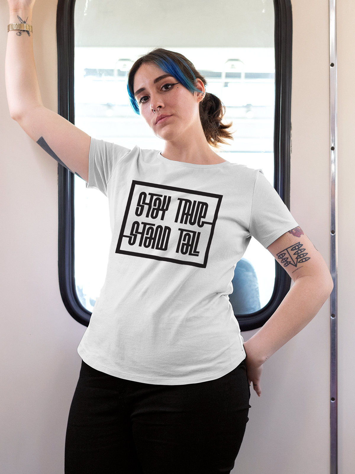 Model wearing Women's White Round Neck T-shirt with 'Stay True Stand Tall' design, offering effortless style and premium comfort