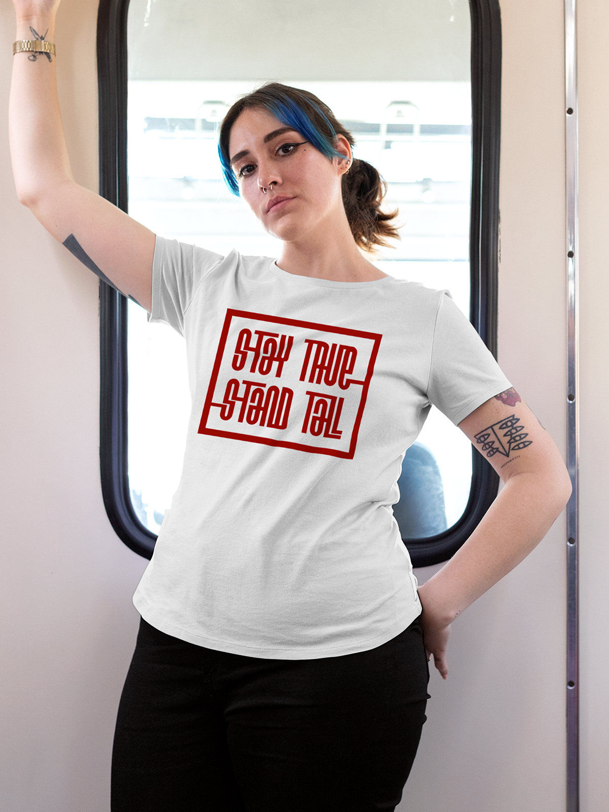Model wearing Women's White Round Neck T-shirt with 'Stay True Stand Tall' design, offering effortless style and premium comfort