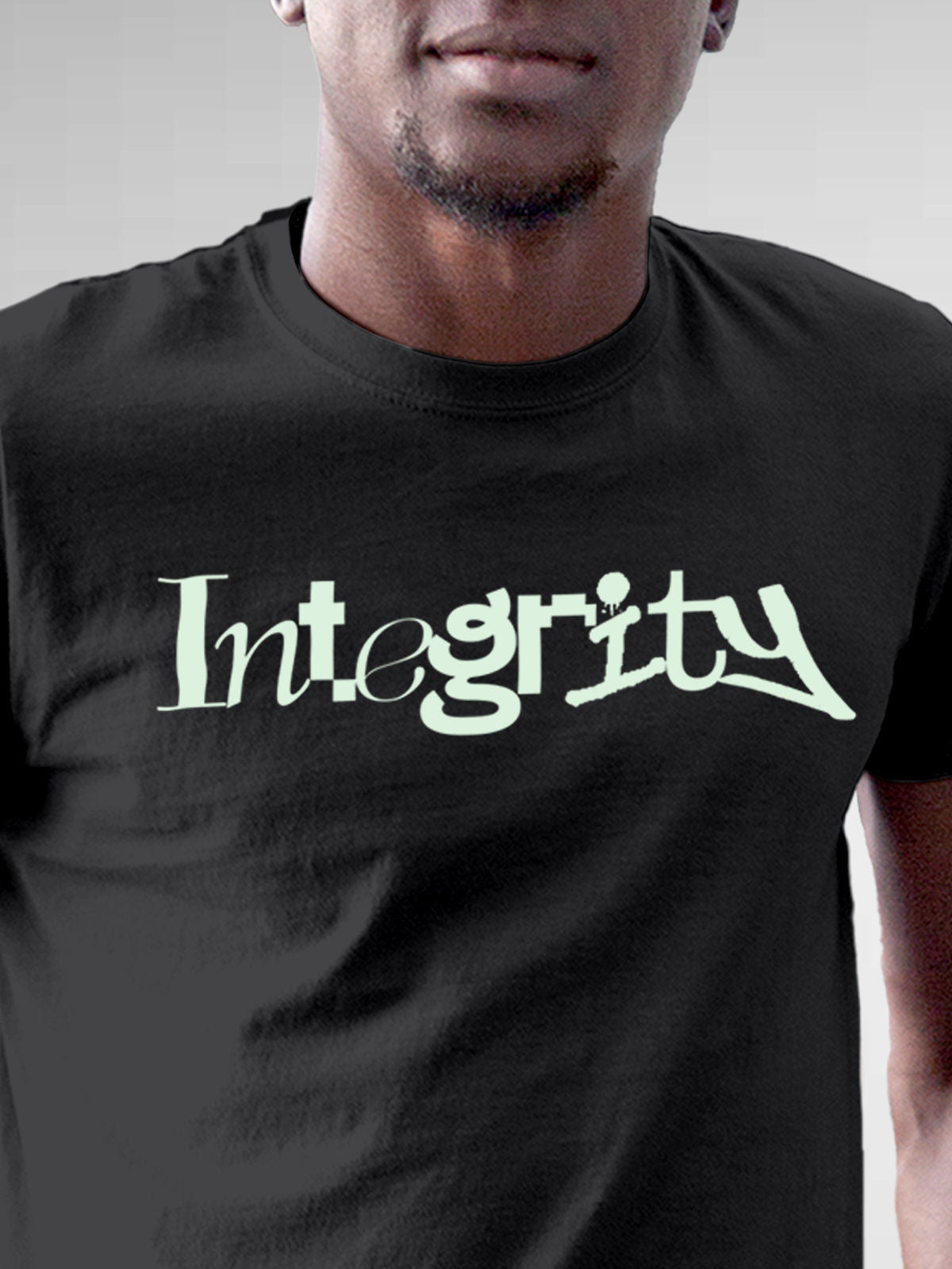 Close up of 'Integrity' design on Men's Dark Grey Round Neck T-shirt, highlighting intricate details and vibrant print.