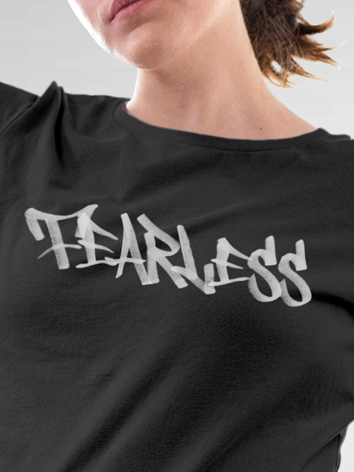 Close up of 'Fearless' design on Women's Dark Grey Round Neck T-shirt, highlighting intricate details and vibrant print.