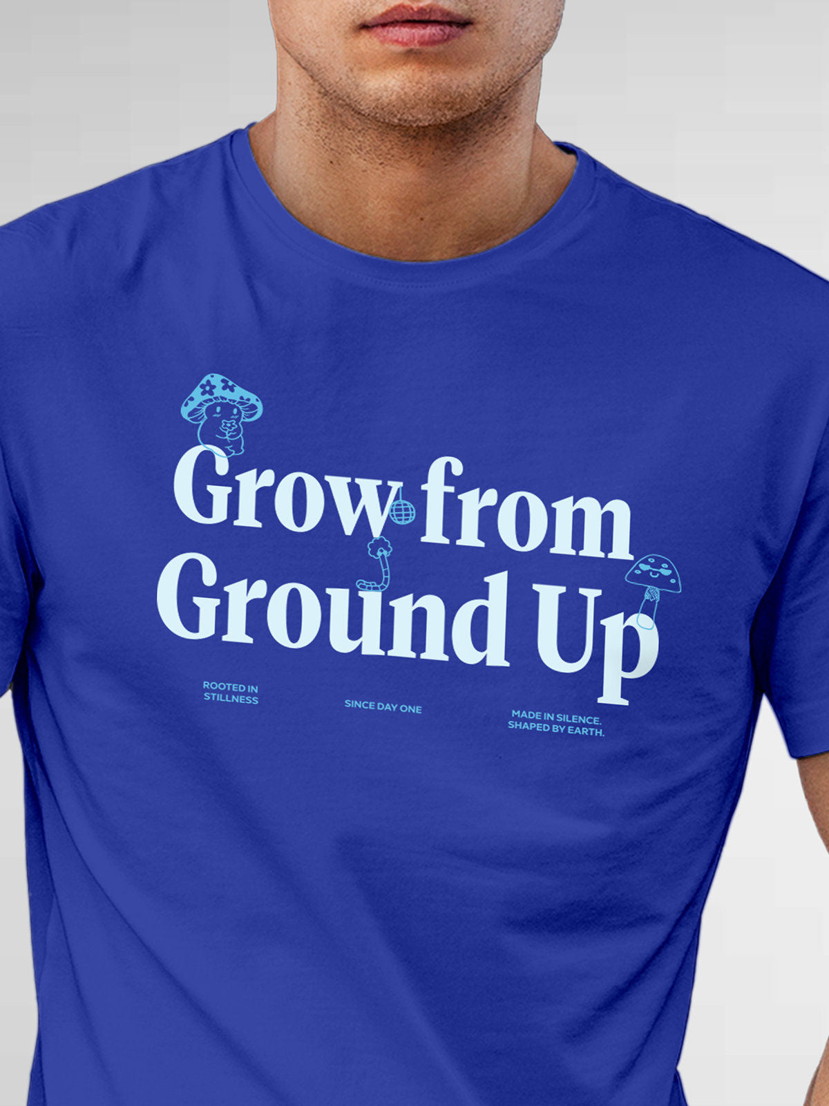 Close up of 'Grow From Ground Up' design on Men's Blue Round Neck T-shirt, highlighting intricate details and vibrant print.
