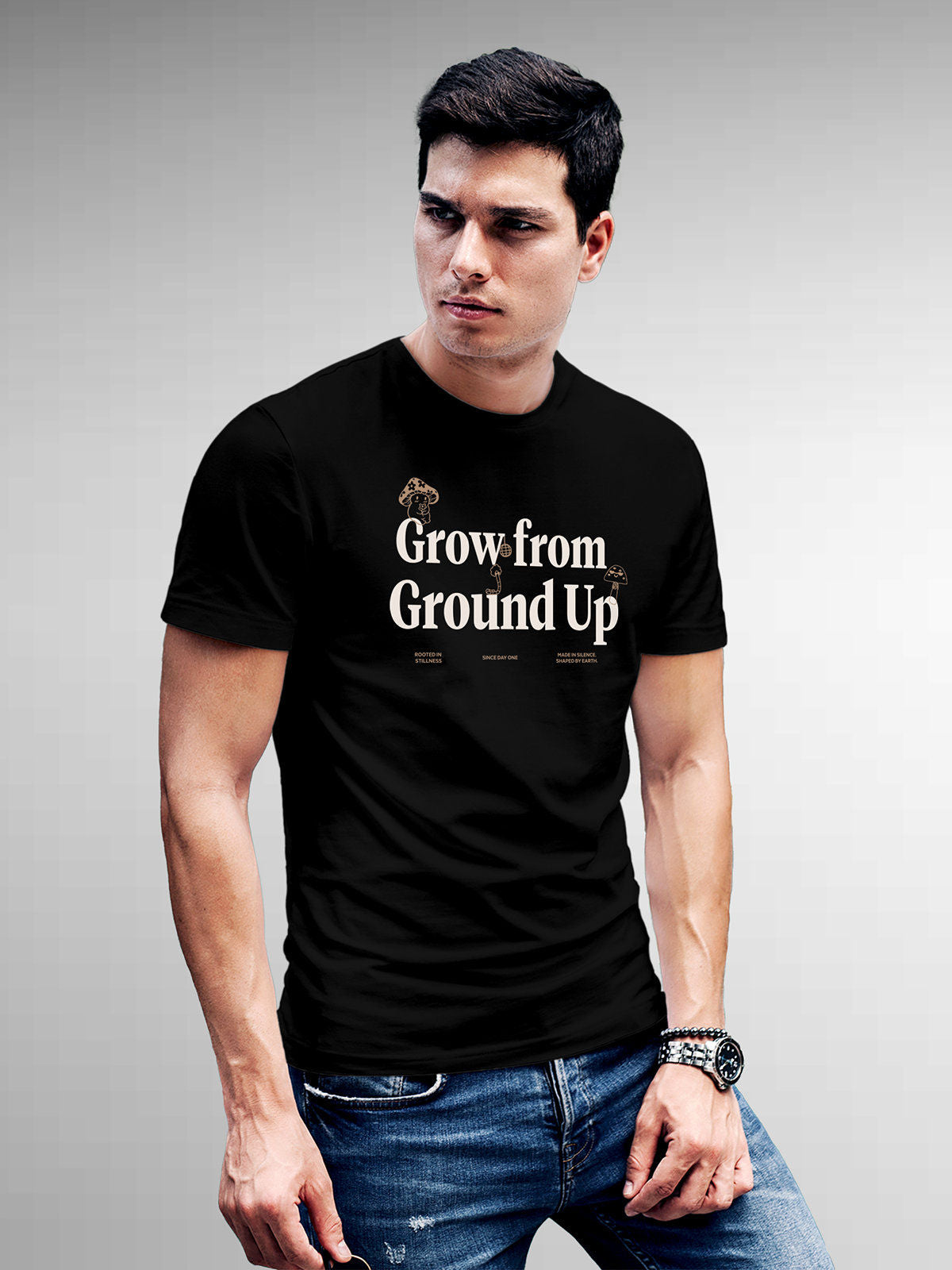 Model wearing Men's Black Round Neck T-shirt with 'Grow From Ground Up' design, offering effortless style and premium comfort