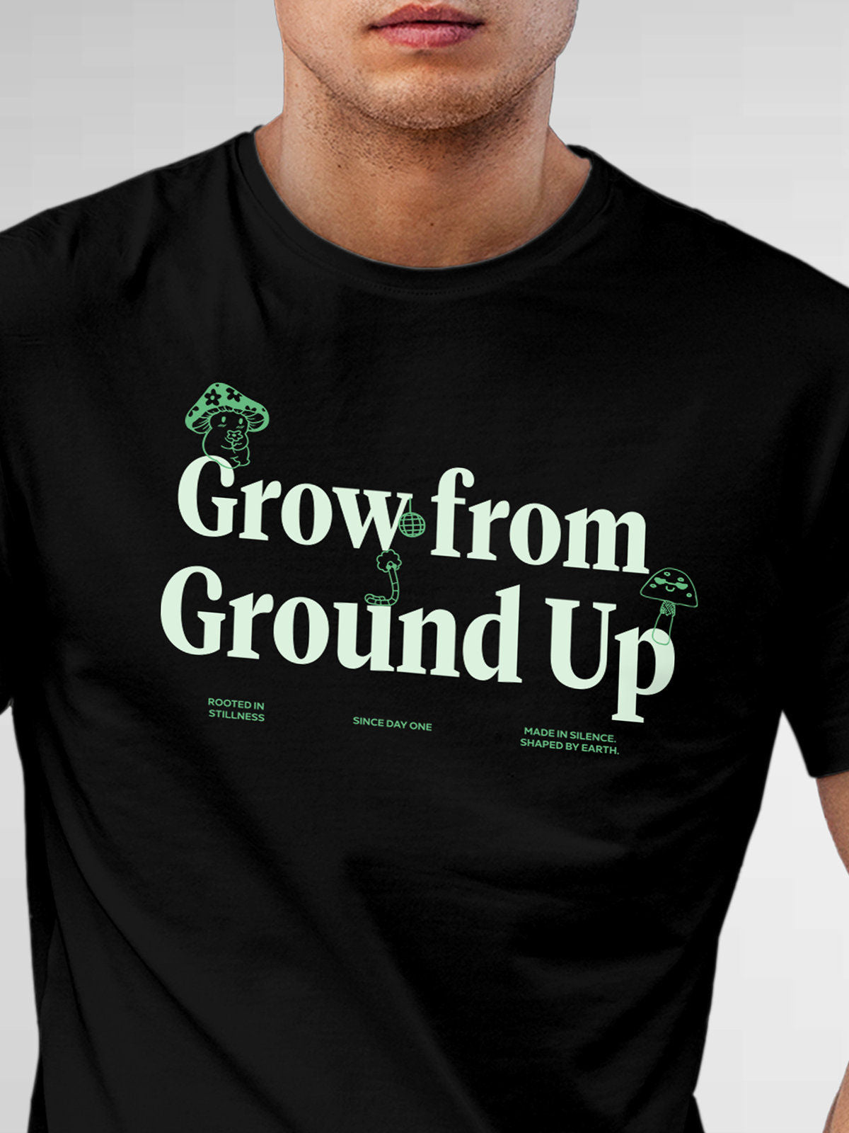 Close up of 'Grow From Ground Up' design on Men's Black Round Neck T-shirt, highlighting intricate details and vibrant print.