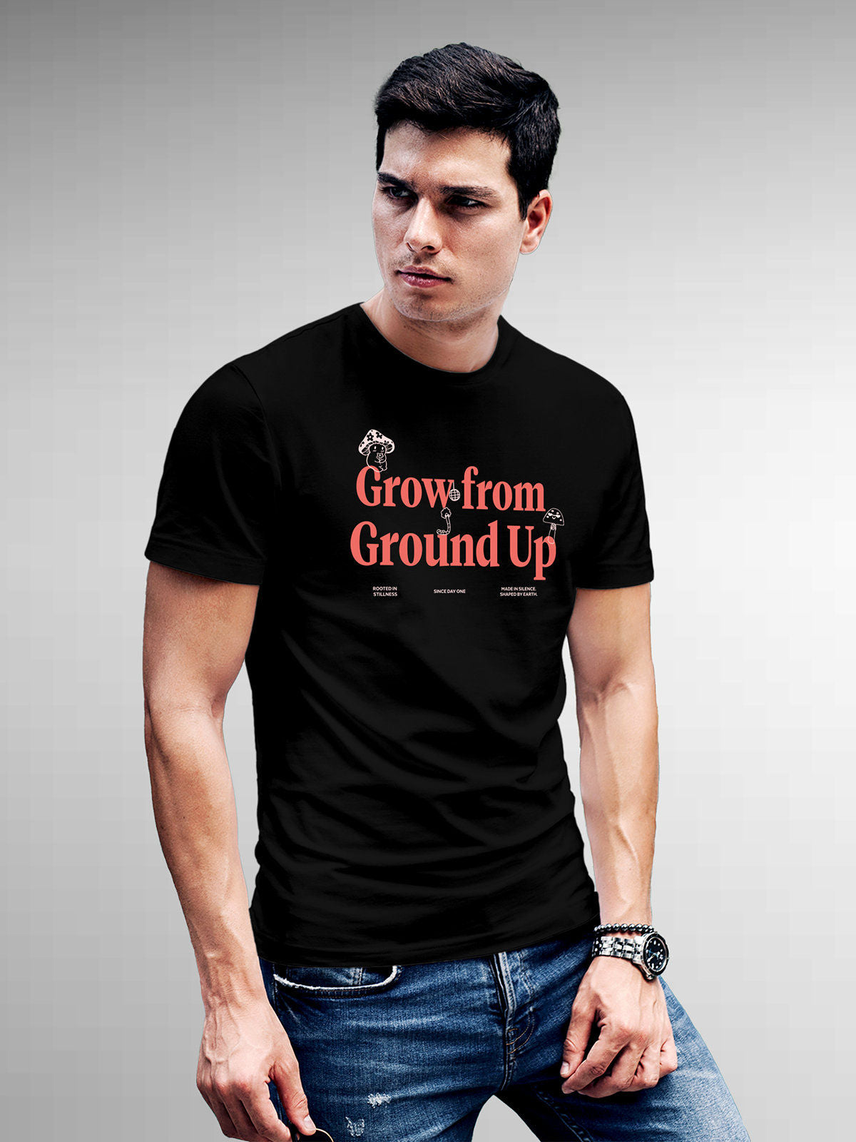 Model wearing Men's Black Round Neck T-shirt with 'Grow From Ground Up' design, offering effortless style and premium comfort