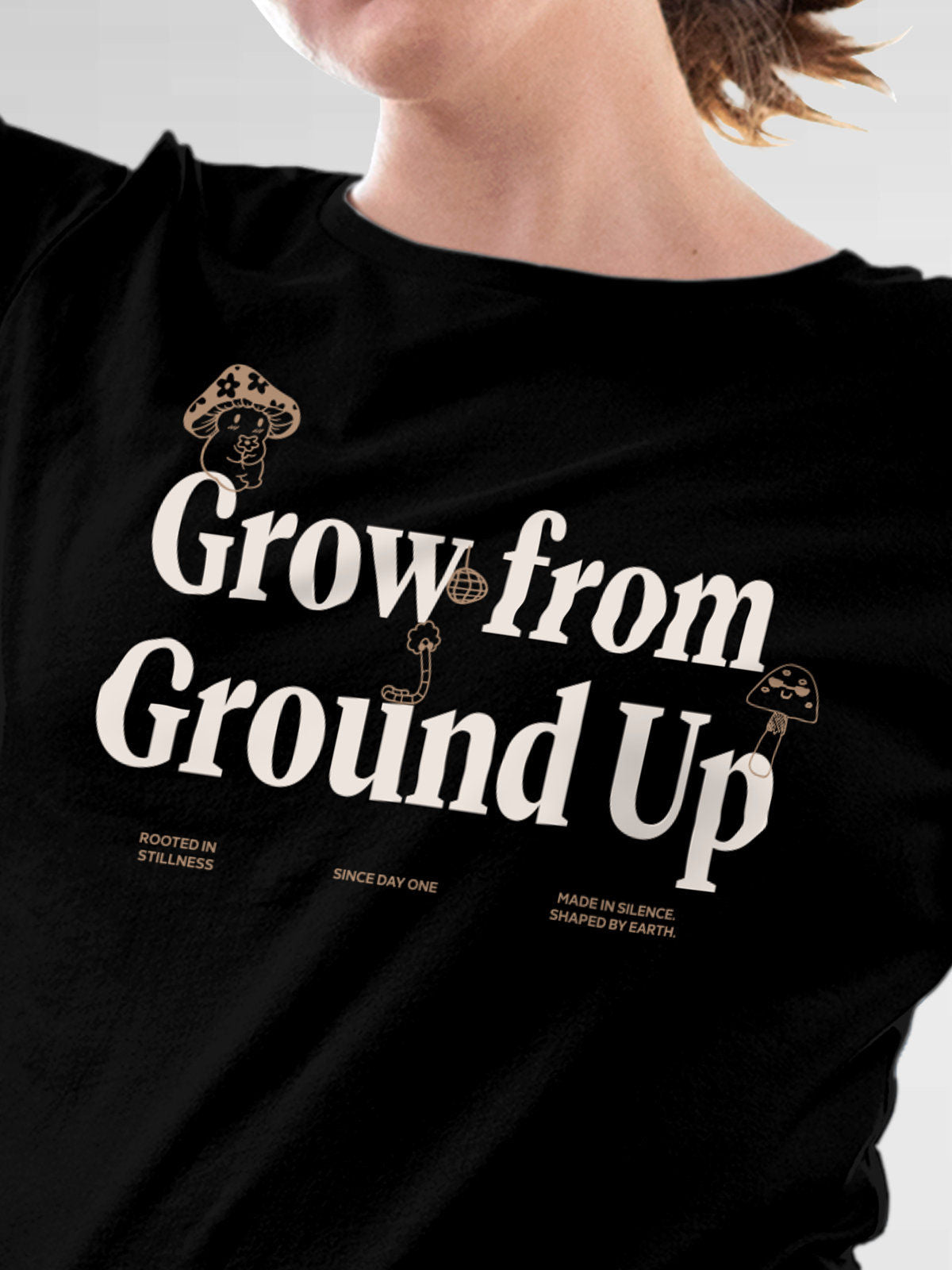 Close up of 'Grow From Ground Up' design on Women's Black Round Neck T-shirt, highlighting intricate details and vibrant print.