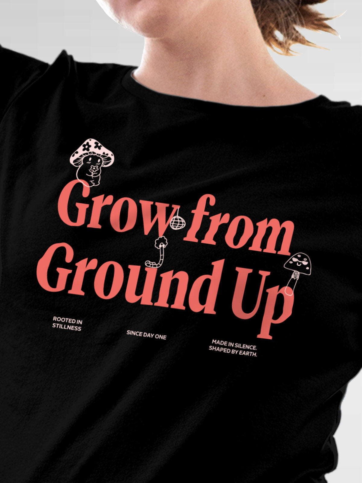 Close up of 'Grow From Ground Up' design on Women's Black Round Neck T-shirt, highlighting intricate details and vibrant print.