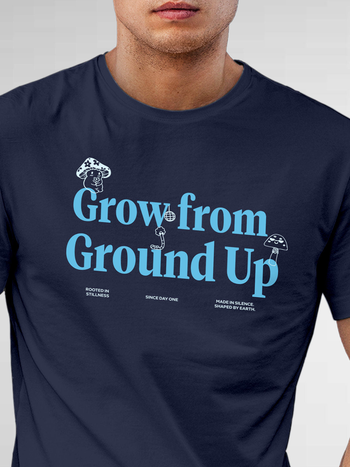 Close up of 'Grow From Ground Up' design on Men's Navy Blue Round Neck T-shirt, highlighting intricate details and vibrant print.