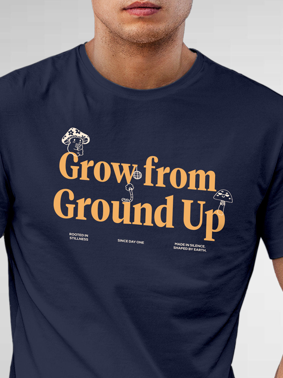 Close up of 'Grow From Ground Up' design on Men's Navy Blue Round Neck T-shirt, highlighting intricate details and vibrant print.