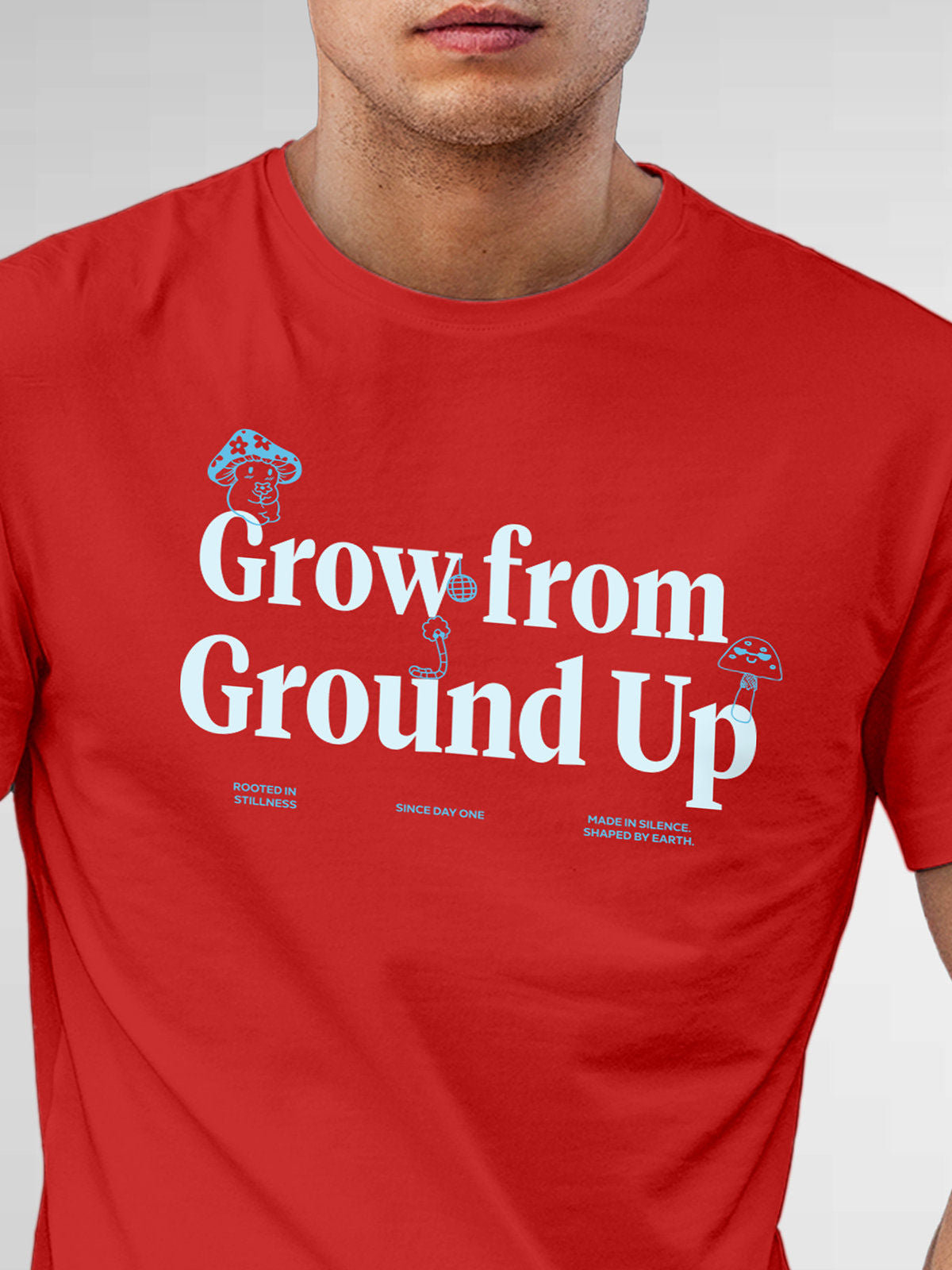 Close up of 'Grow From Ground Up' design on Men's Red Round Neck T-shirt, highlighting intricate details and vibrant print.