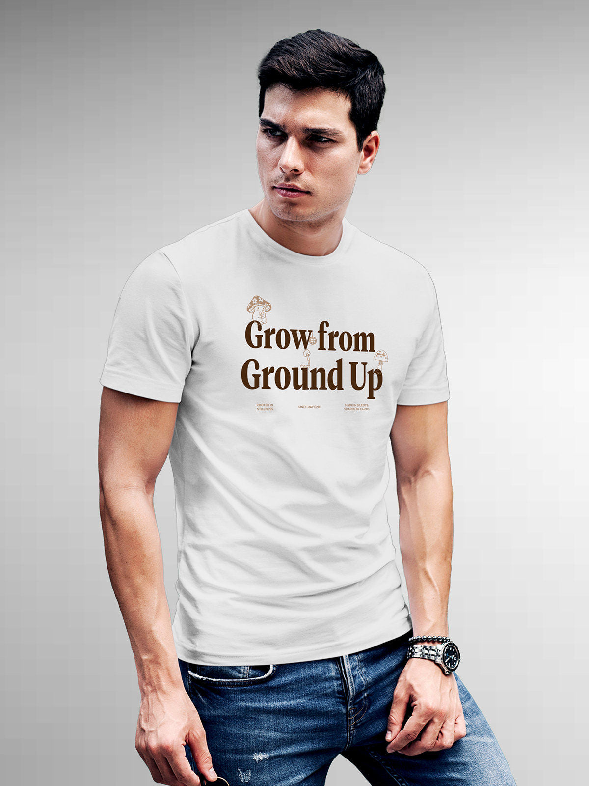 Model wearing Men's White Round Neck T-shirt with 'Grow From Ground Up' design, offering effortless style and premium comfort