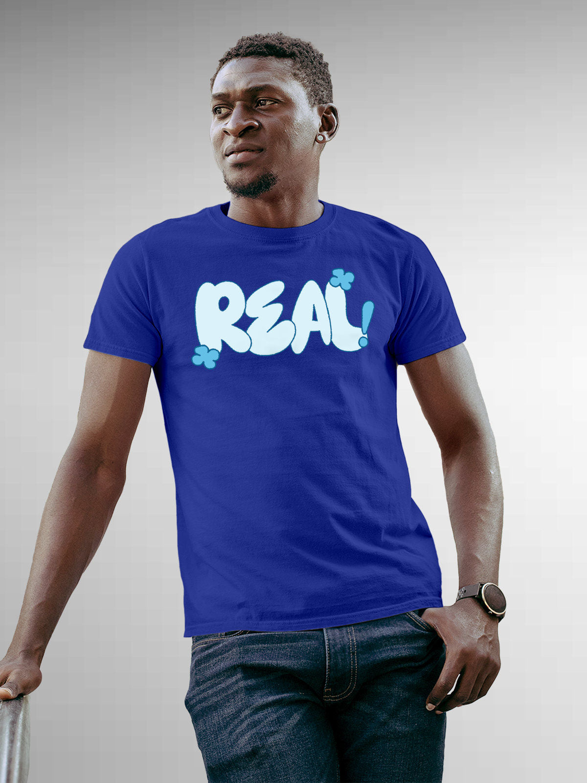 Model wearing Men's Blue Round Neck T-shirt with 'Real' design, offering effortless style and premium comfort