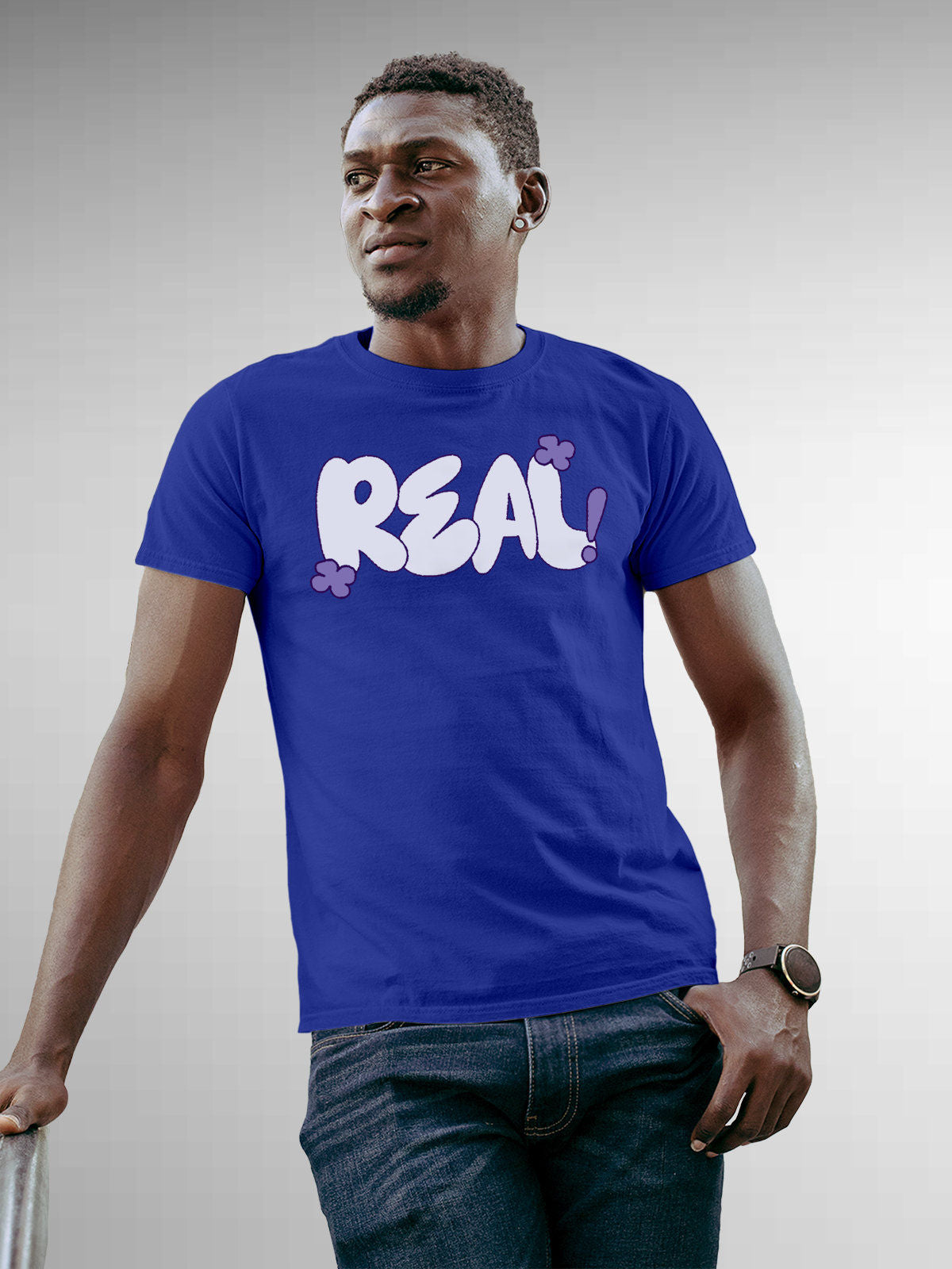 Model wearing Men's Blue Round Neck T-shirt with 'Real' design, offering effortless style and premium comfort