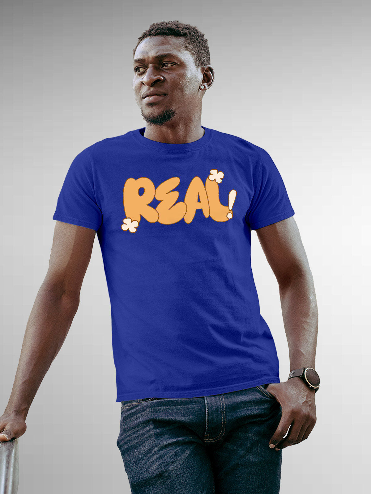 Model wearing Men's Blue Round Neck T-shirt with 'Real' design, offering effortless style and premium comfort