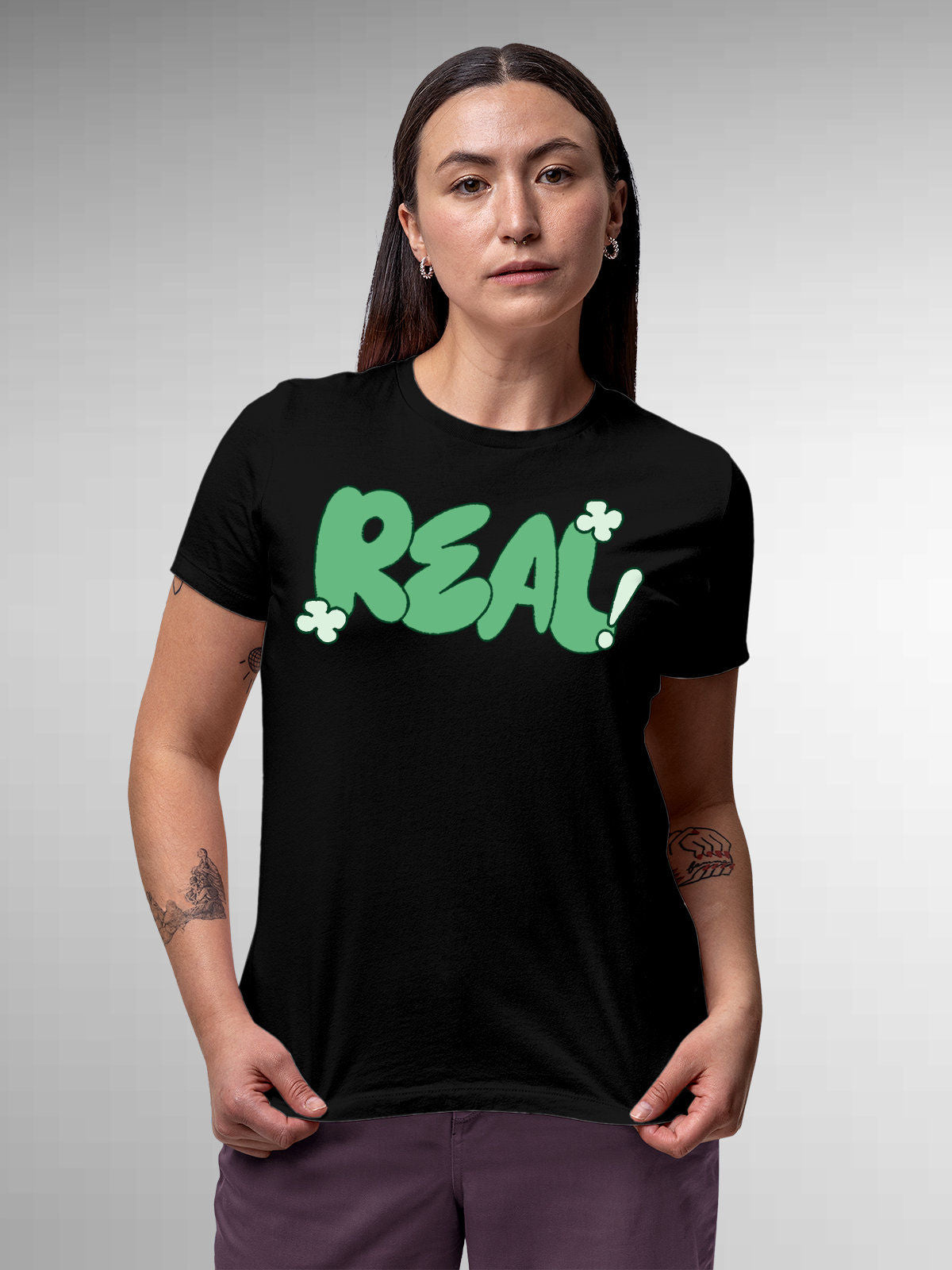 Model wearing Women's Black Round Neck T-shirt with 'Real' design, offering effortless style and premium comfort