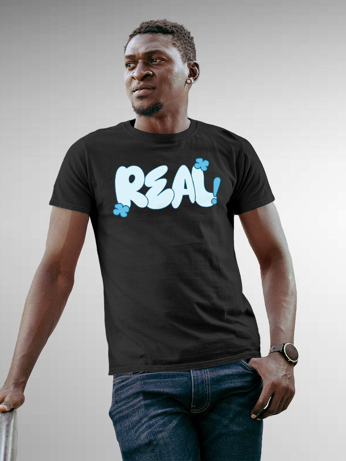 Model wearing Men's Dark Grey Round Neck T-shirt with 'Real' design, offering effortless style and premium comfort