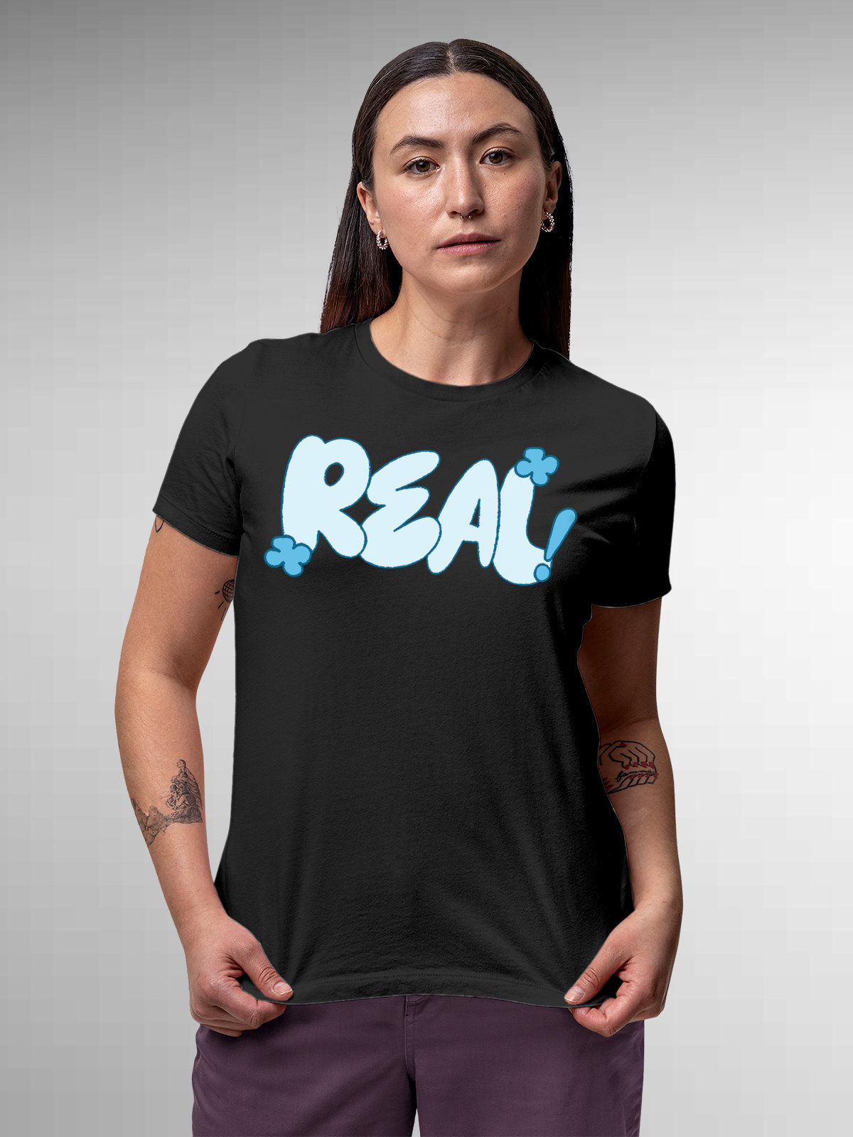 Model wearing Women's Dark Grey Round Neck T-shirt with 'Real' design, offering effortless style and premium comfort