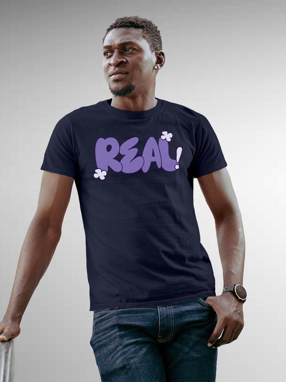 Model wearing Men's Navy Blue Round Neck T-shirt with 'Real' design, offering effortless style and premium comfort