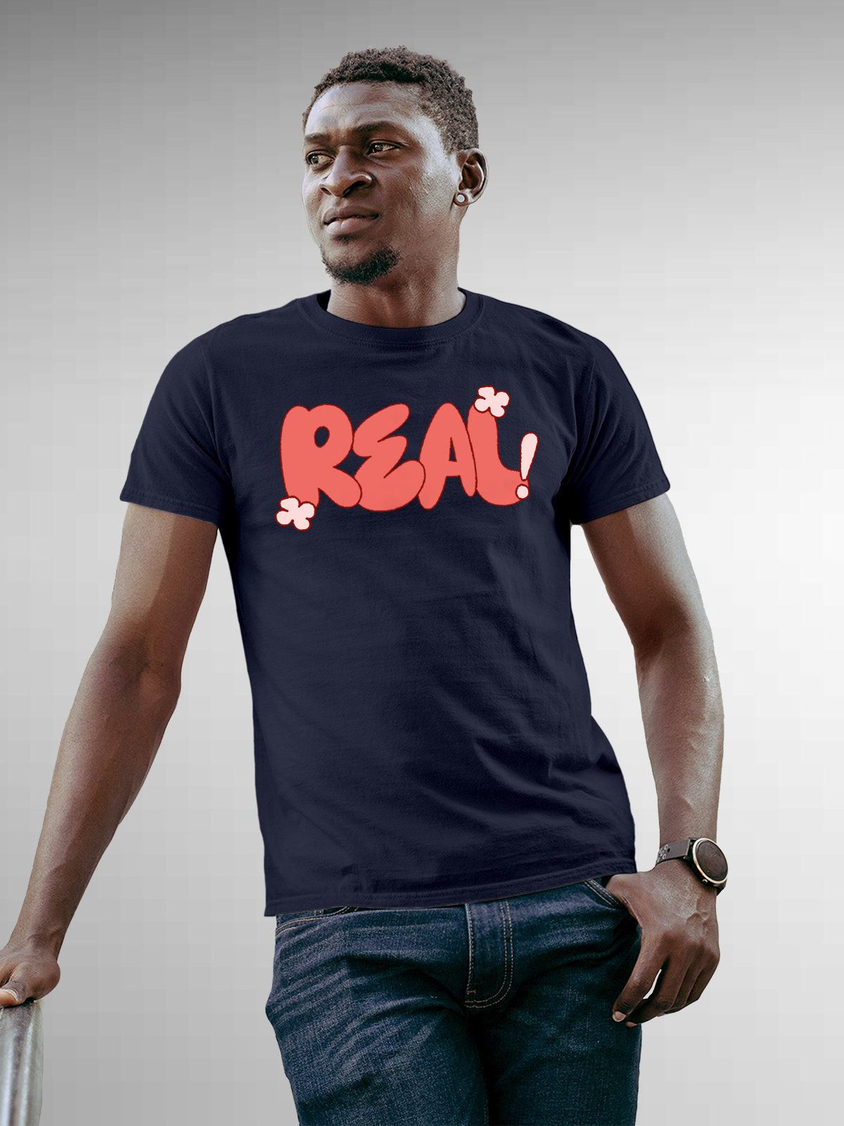 Model wearing Men's Navy Blue Round Neck T-shirt with 'Real' design, offering effortless style and premium comfort