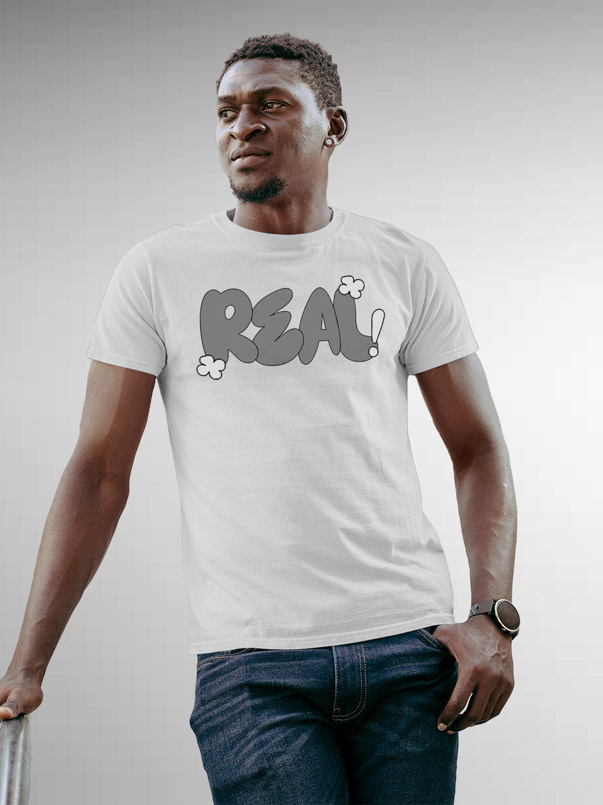 Model wearing Men's White Round Neck T-shirt with 'Real' design, offering effortless style and premium comfort