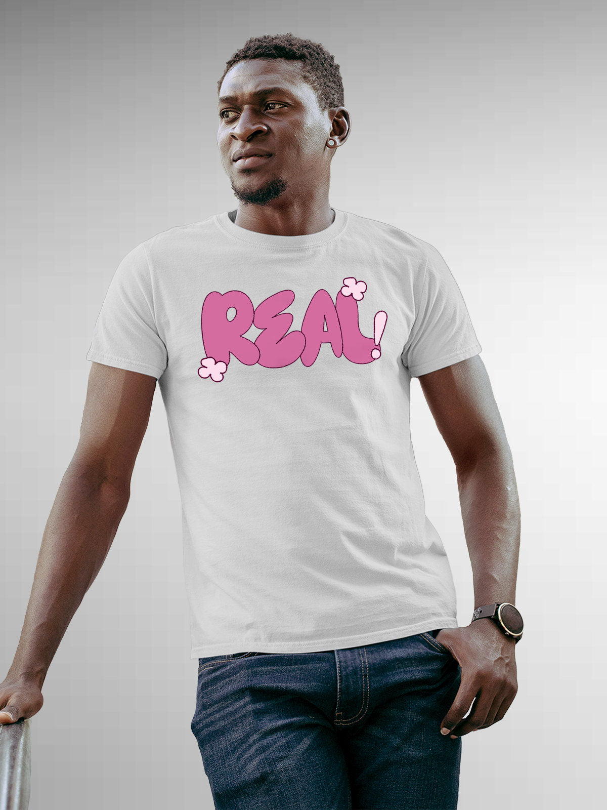Model wearing Men's White Round Neck T-shirt with 'Real' design, offering effortless style and premium comfort