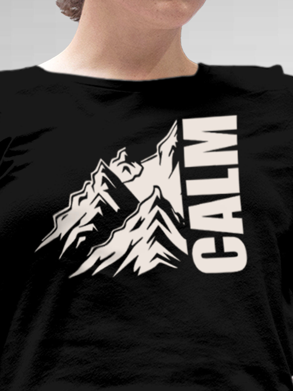 Close up of 'Calm' design on Women's Black Round Neck T-shirt, highlighting intricate details and vibrant print.