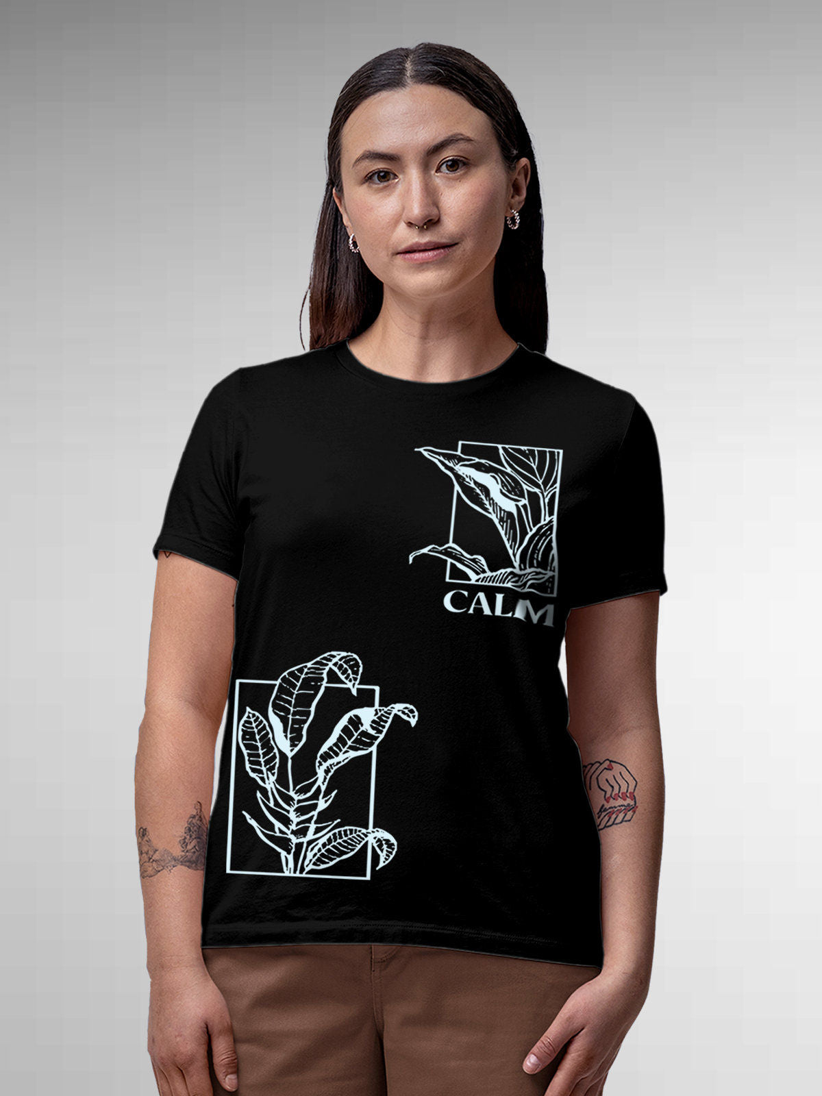 Model wearing Women's Black Round Neck T-shirt with 'Calm' design, offering effortless style and premium comfort