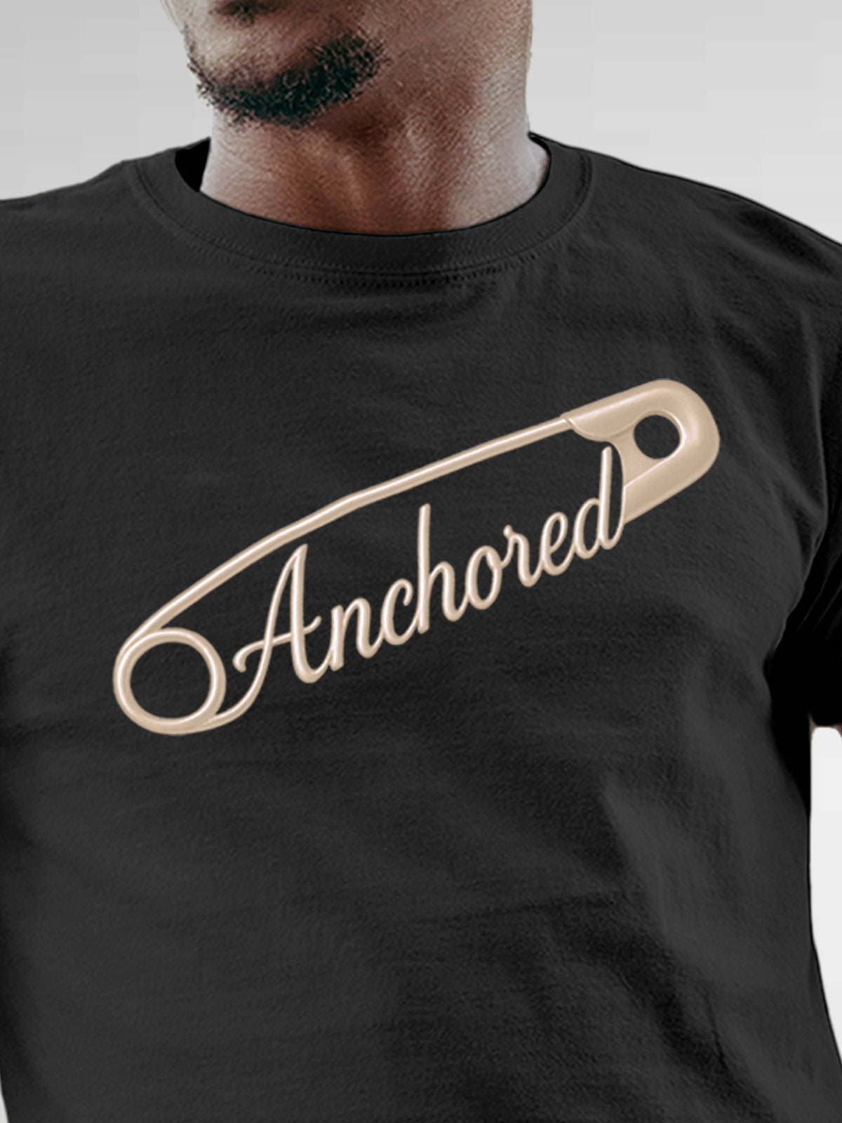 Close up of 'Anchored' design on Men's Dark Grey Round Neck T-shirt, highlighting intricate details and vibrant print.